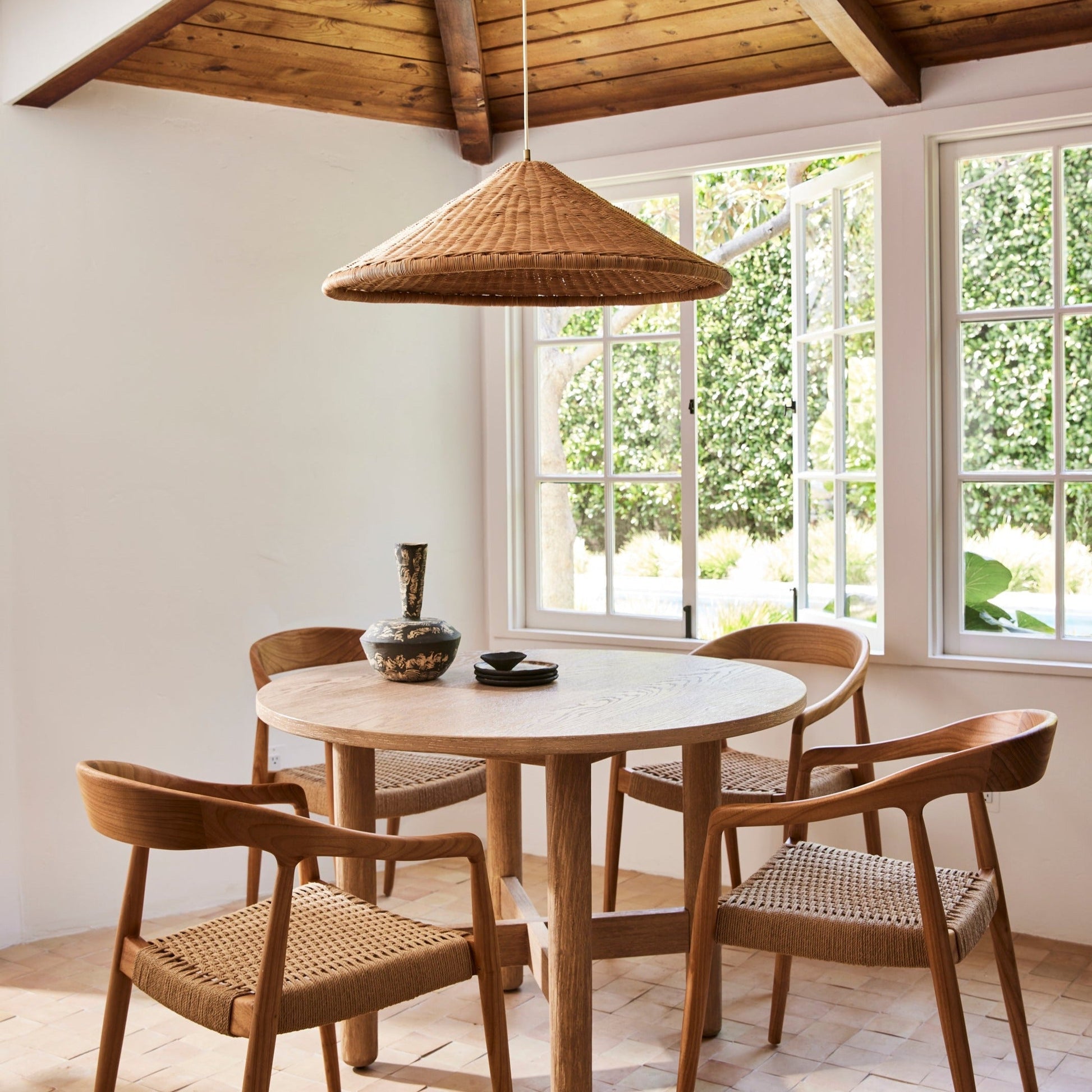 The medium-sized rattan pendant lamp in a breakfast nook.