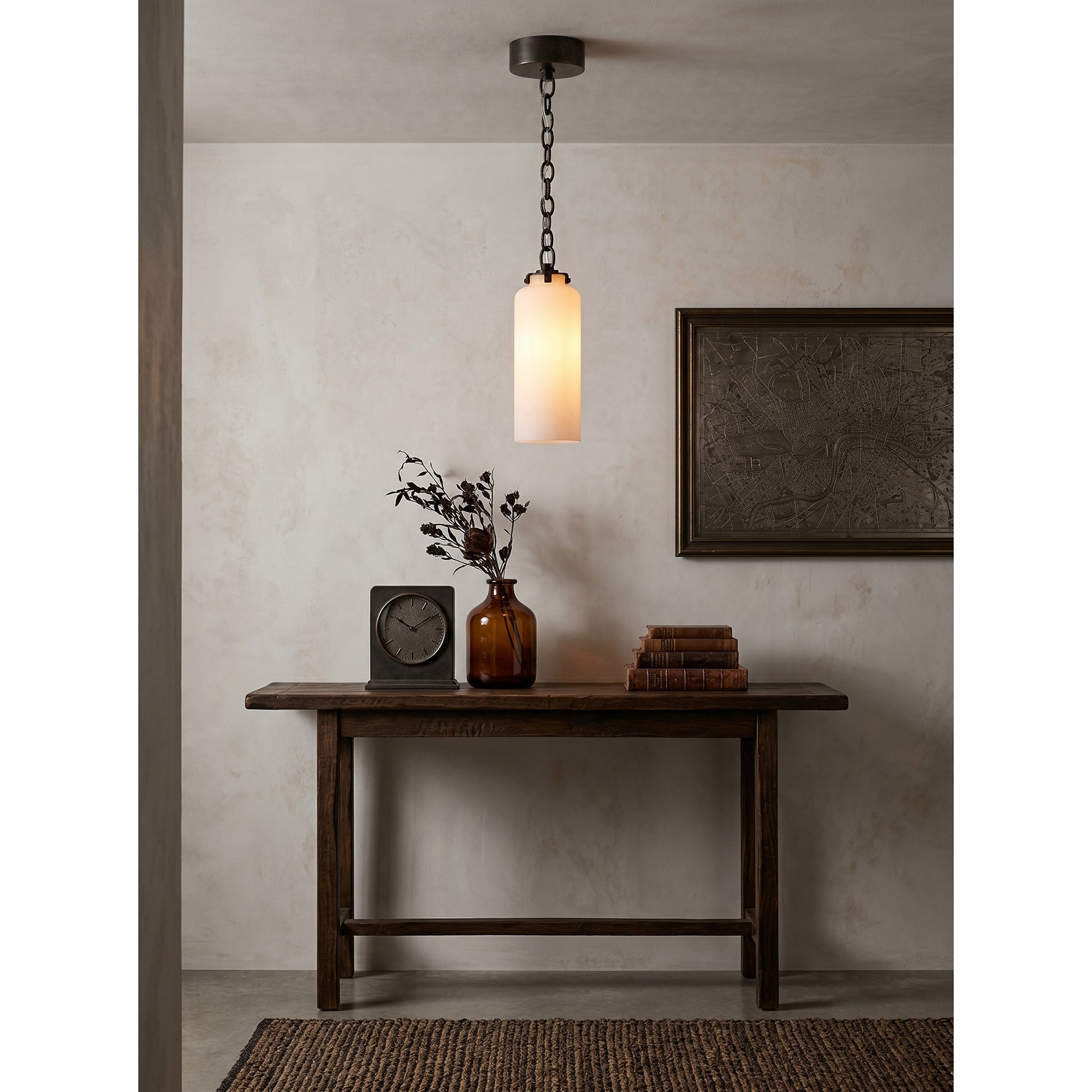 Katie Pendant Lamp shown against a dark-colored wall.