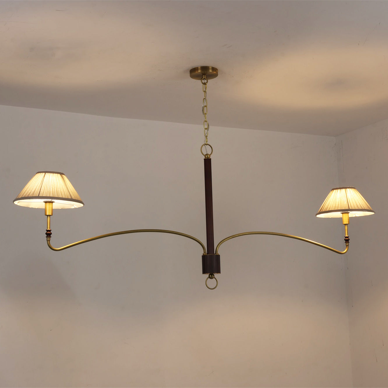 The brass finish of the Laurent Chandelier reflecting light.