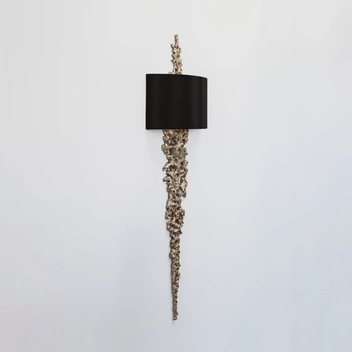 The Lava Wall Sconce presented as a piece of sculptural wall art.