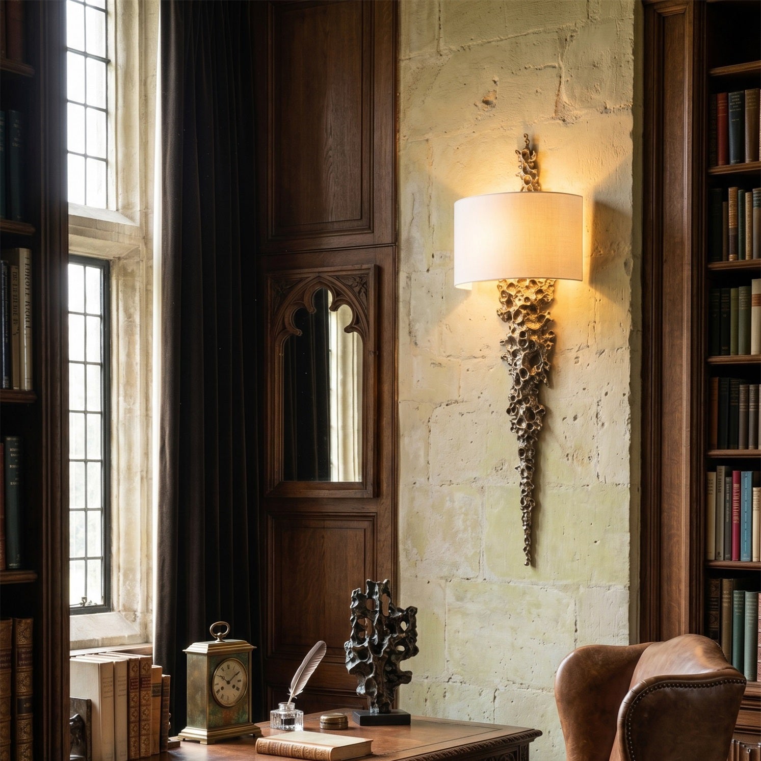 Angled view of the Brutalist-inspired brass wall sconce.