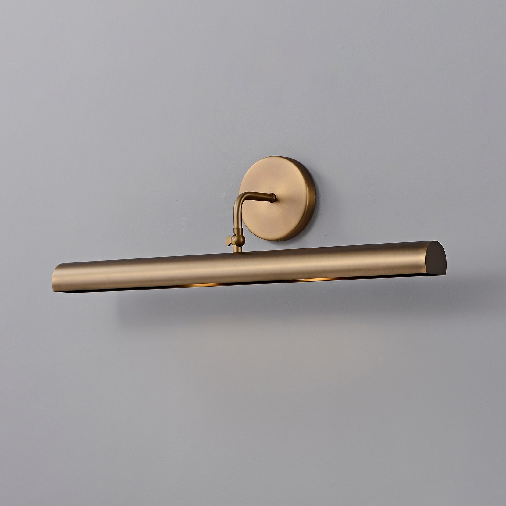 Loxen Wall Sconce turned on, casting a warm glow.