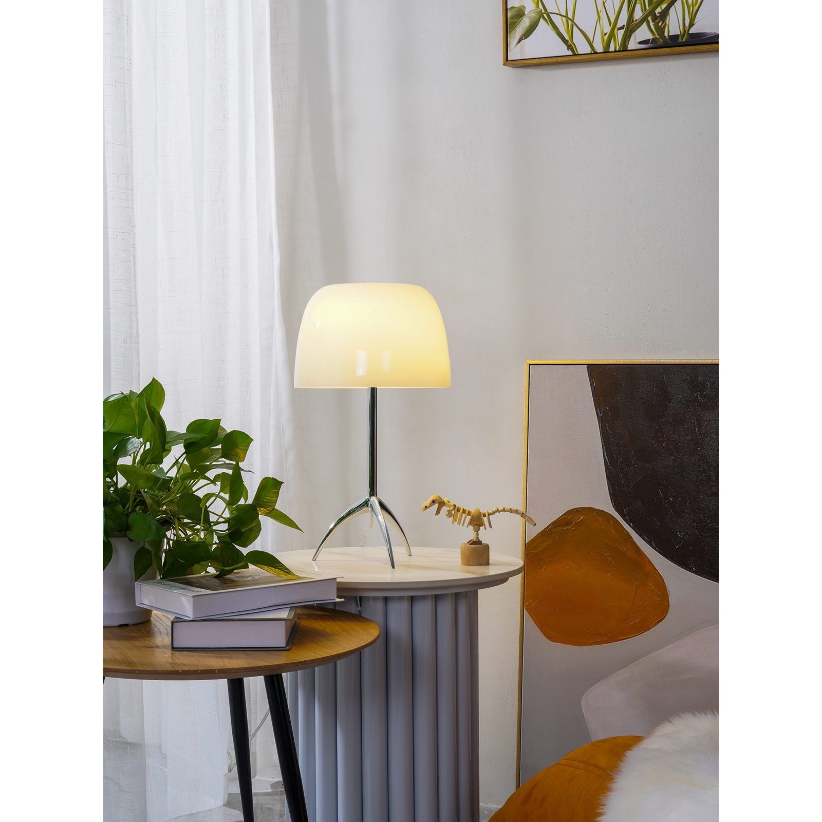 Lumiere Table Lamp as an accent light on a bookshelf.