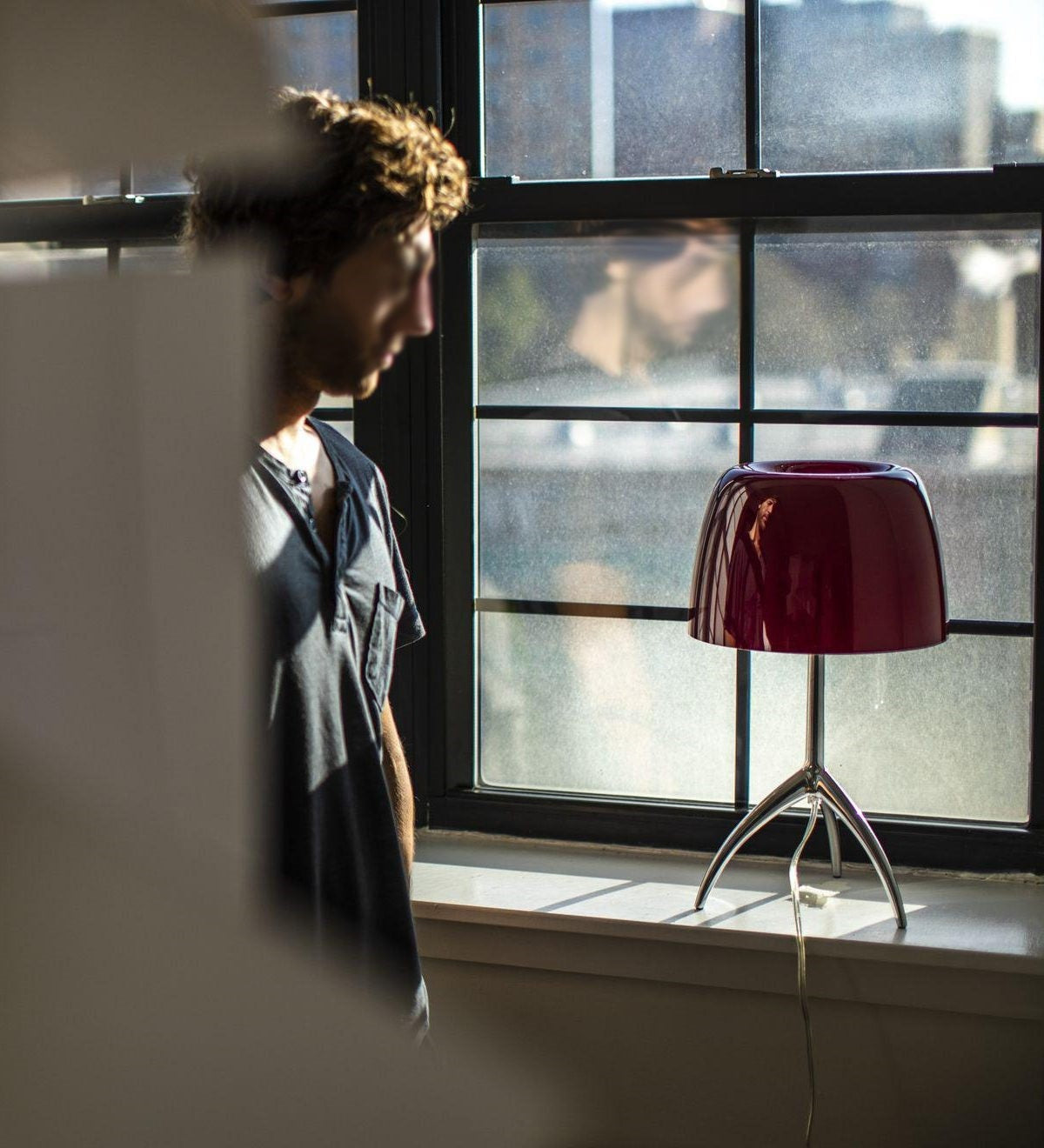 Close-up of the red blown glass shade of the Lumiere Table Lamp.