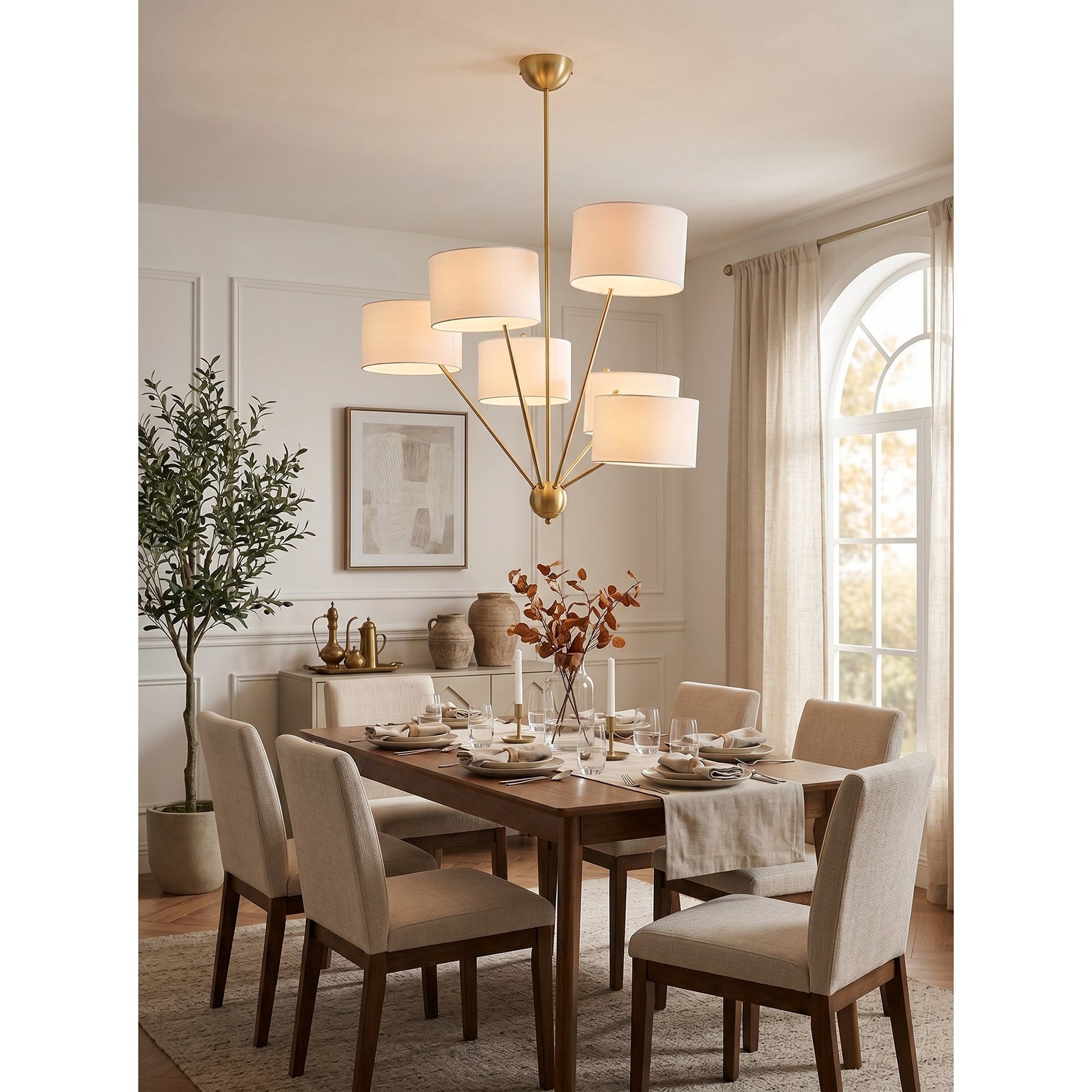 Lifestyle image of the Mantis Chandelier in a chic primary suite.