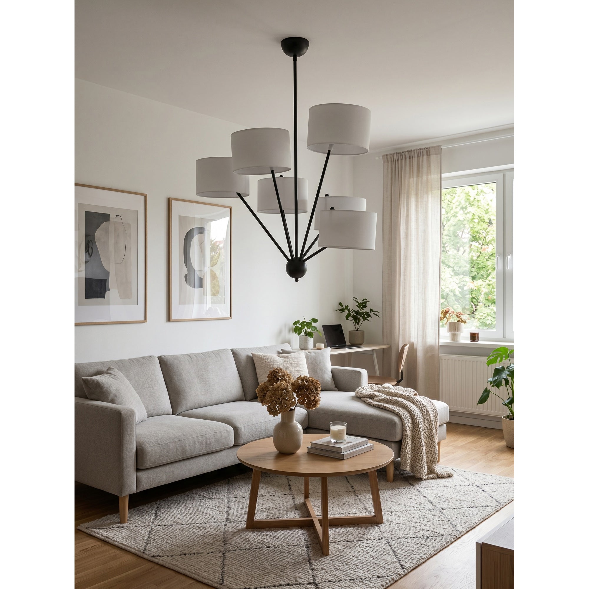 The Mantis Chandelier illuminating a contemporary dining room table.