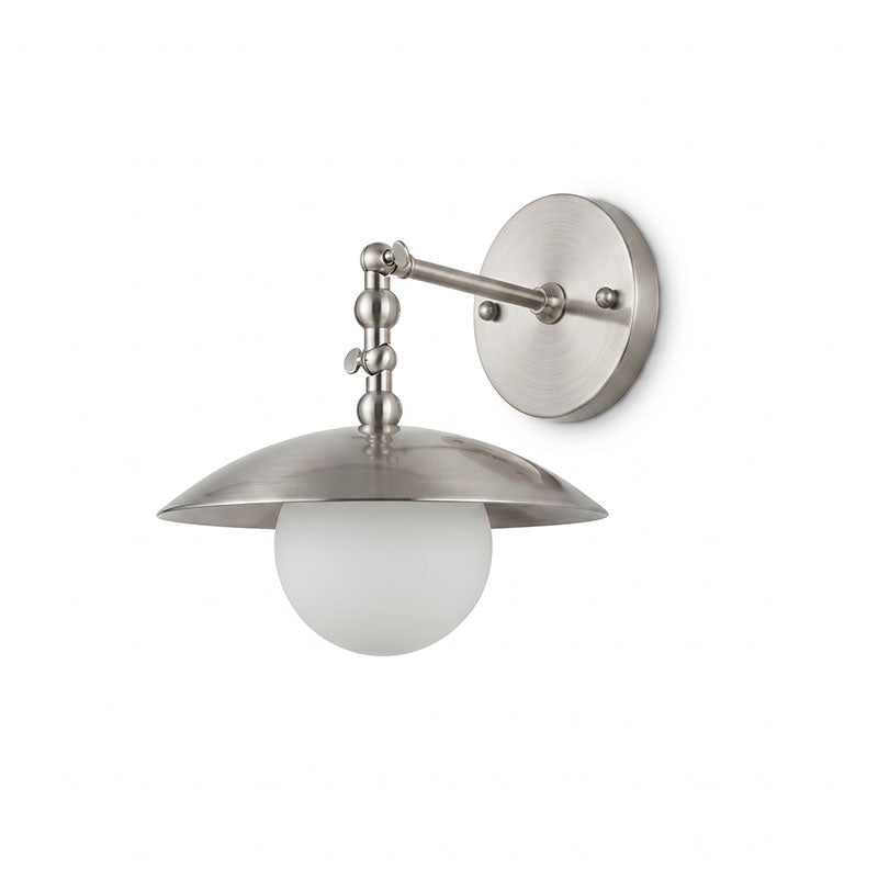 Lifestyle image showing the sconce above a bedside table.