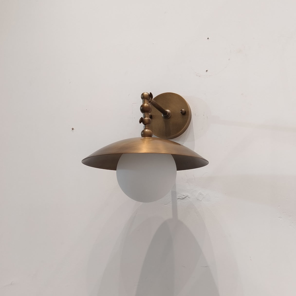 Installation context showing the sconce mounted on a wall.