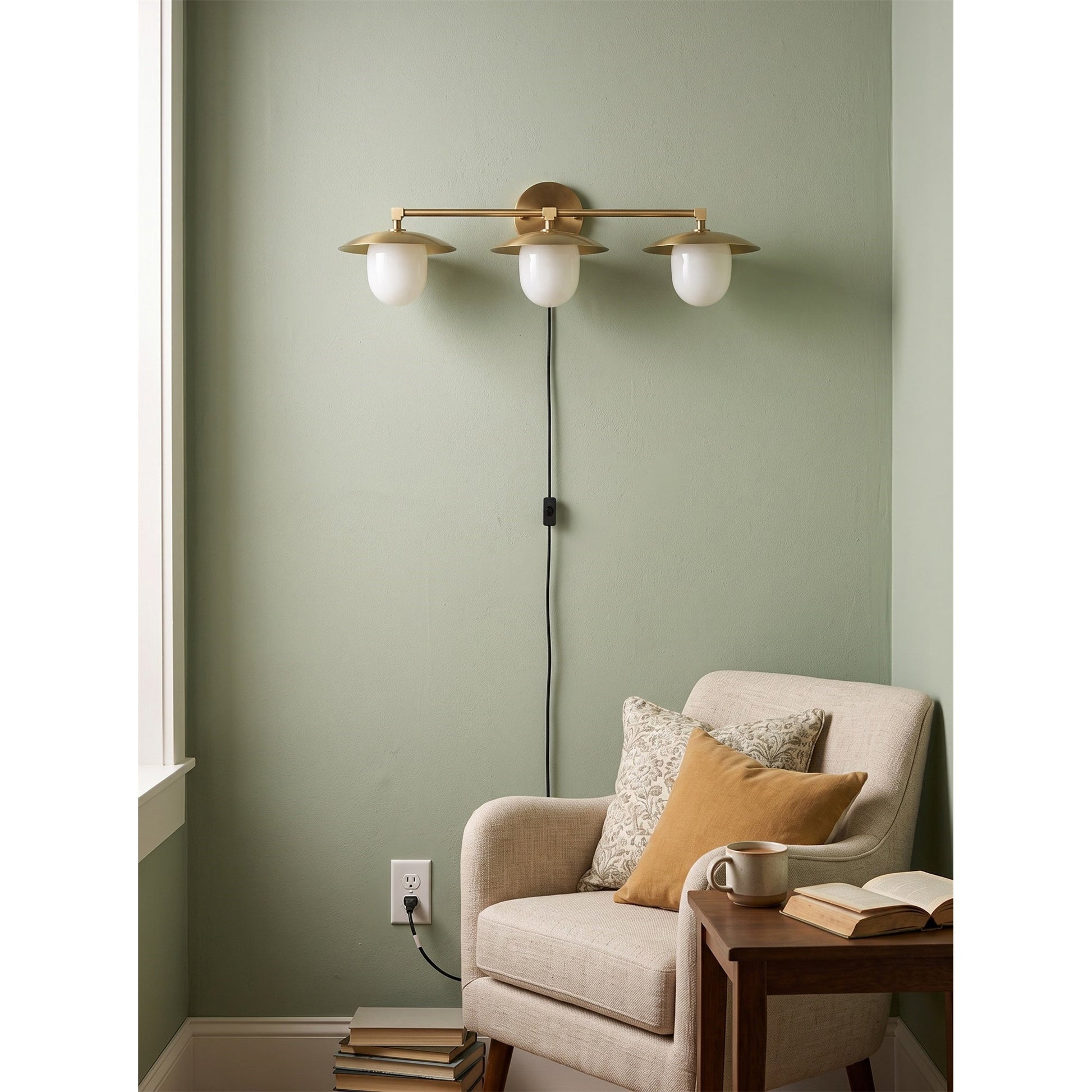 Marie wall sconce installed above a living room console table.