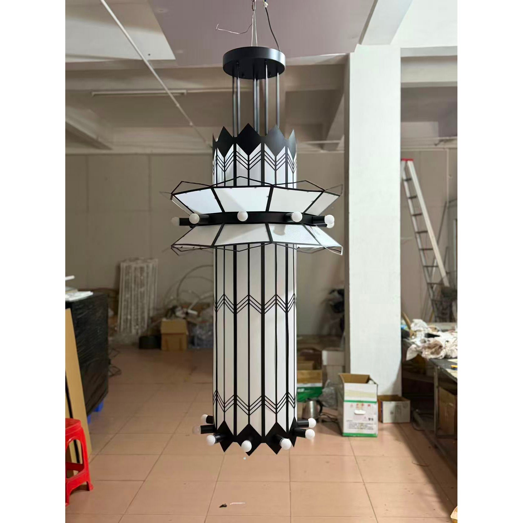 The black Mariel Chandelier shown from a distance to illustrate its scale.