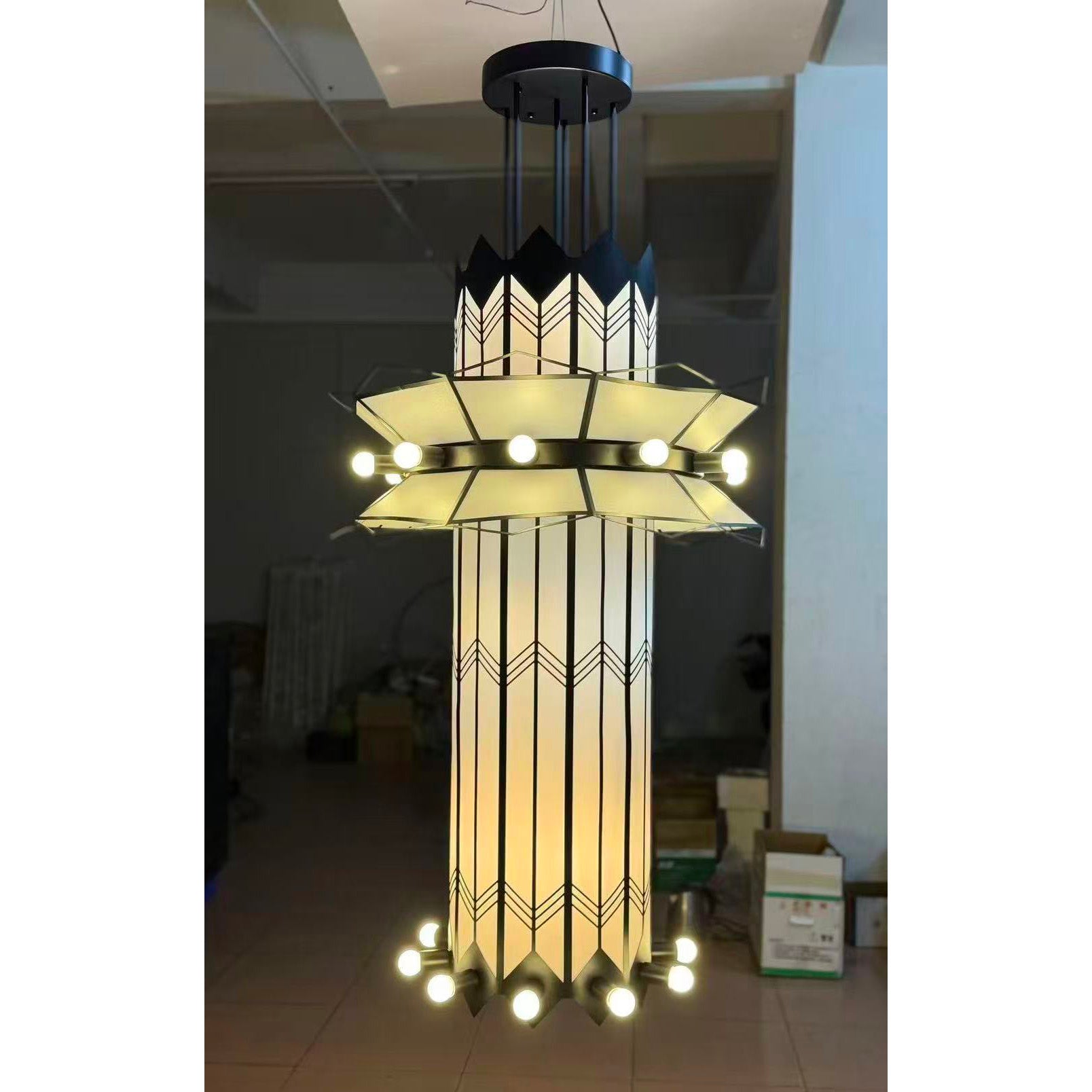 The white Mariel Chandelier shown from a distance in a large space.