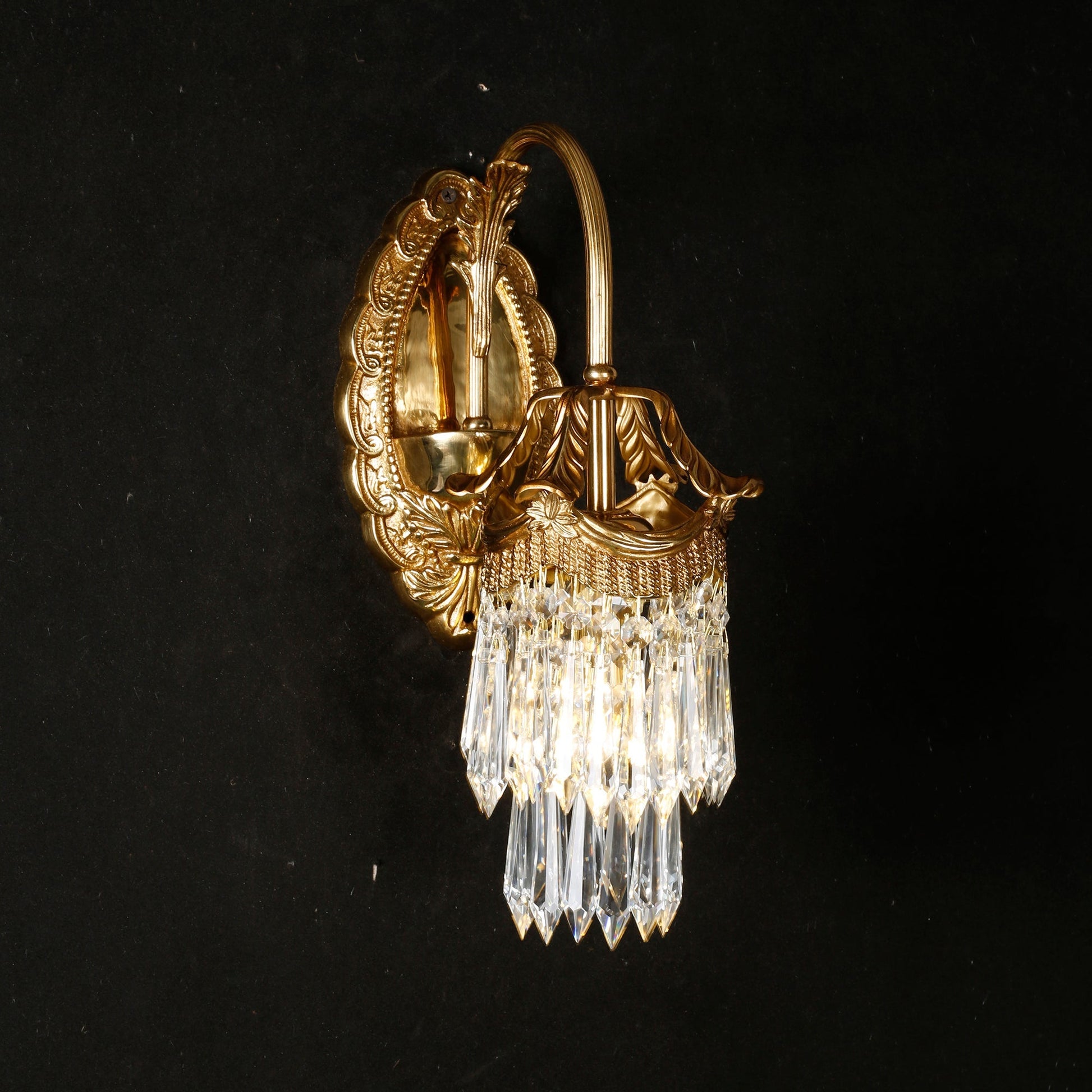 Two Mayfield sconces elegantly framing a gilded mirror.
