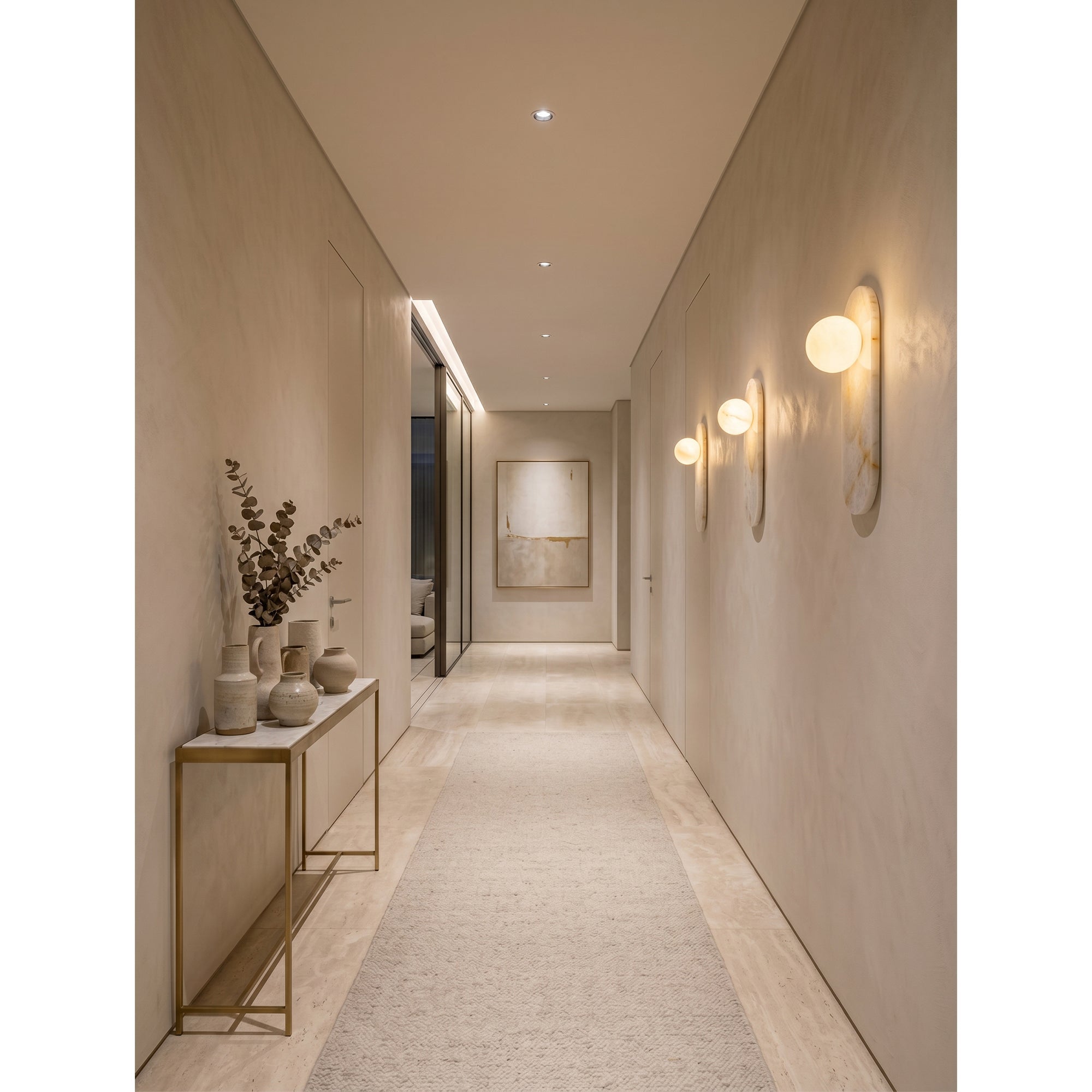 The sconce illuminated, demonstrating the soft, warm glow through the alabaster.