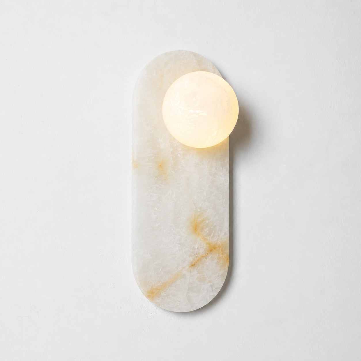 The 3-head sconce illuminating a tall, narrow wall space.