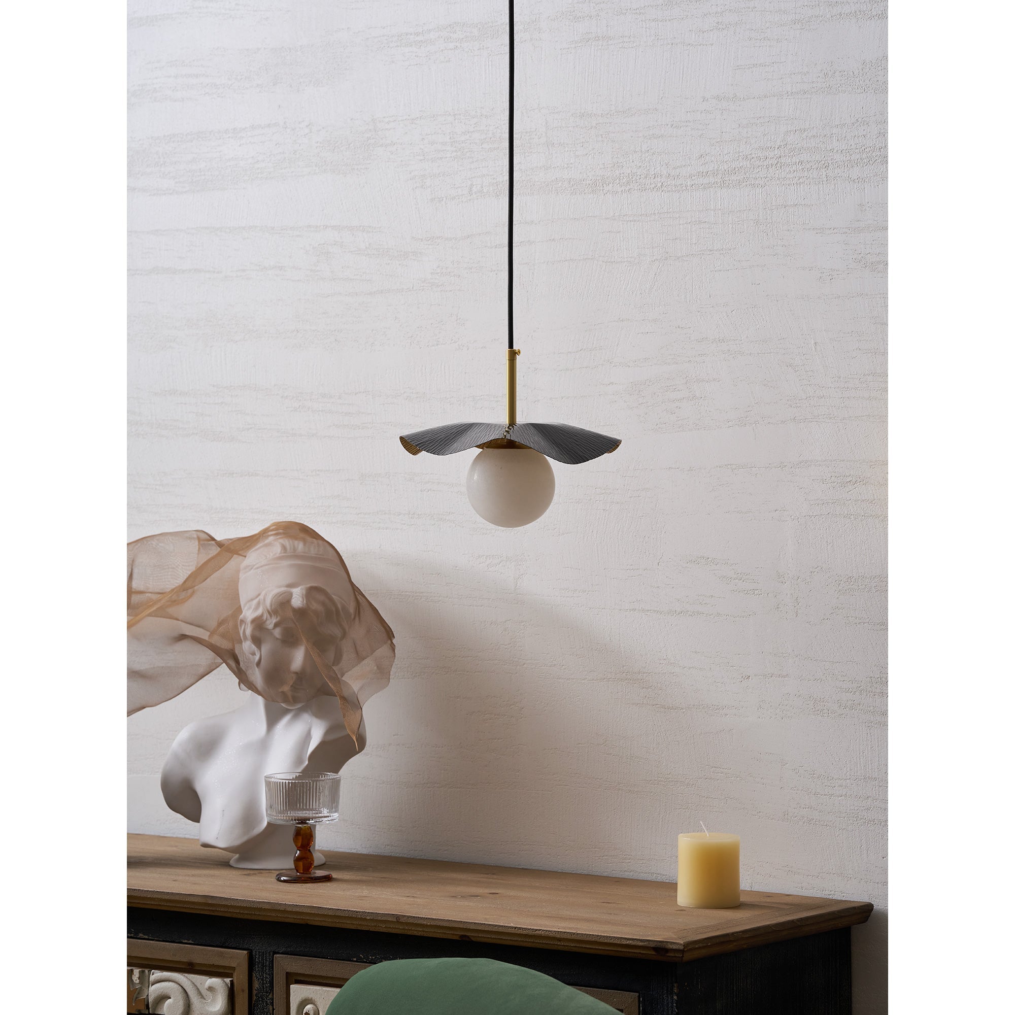The pendant lamp used as a bedside light in a contemporary bedroom.