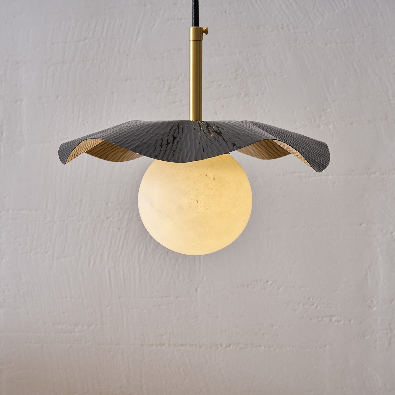 Side profile of the Bonnie Alabaster Pendant Lamp showcasing its form.