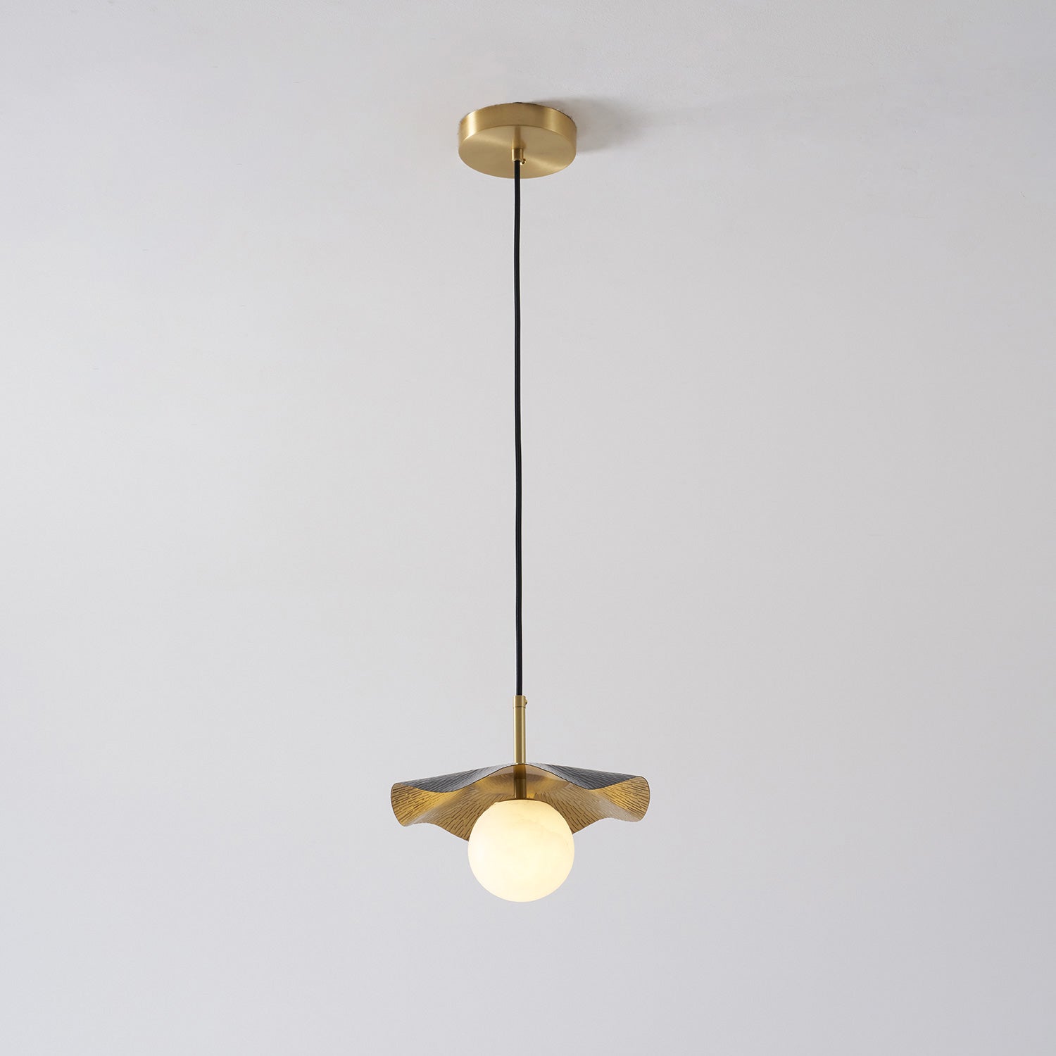 Lifestyle image of the pendant lamp in a minimalist entryway.