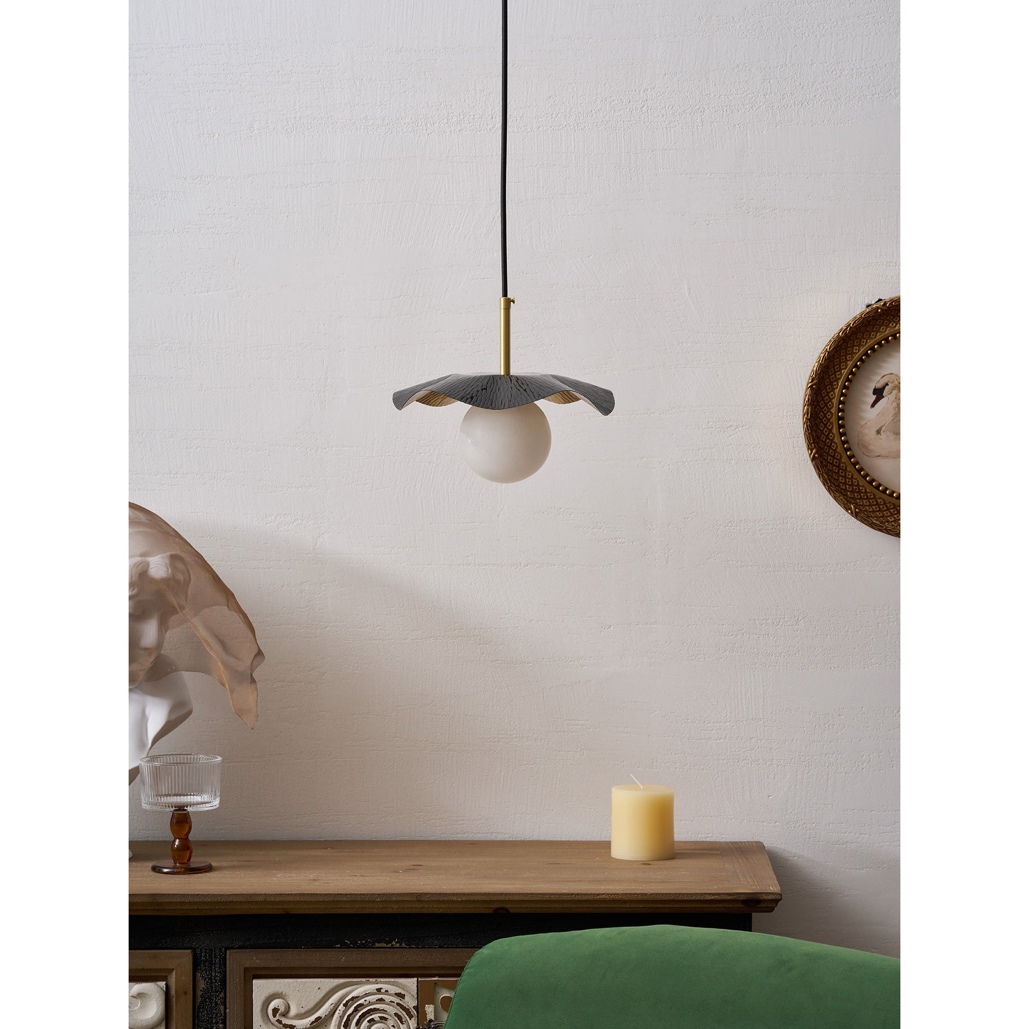 The alabaster sphere glowing softly in a dimly lit room.