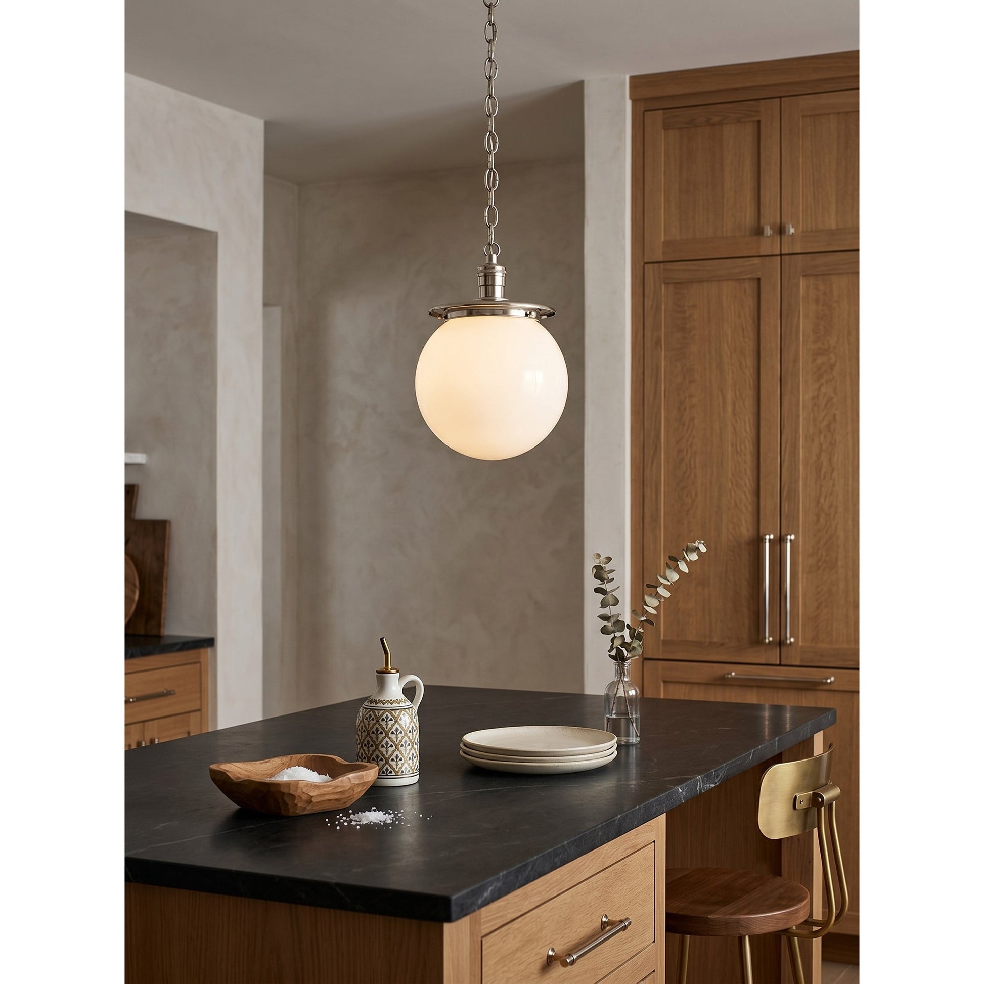 Nolan Globe Pendant Lamp in a black finish with a white glass shade.