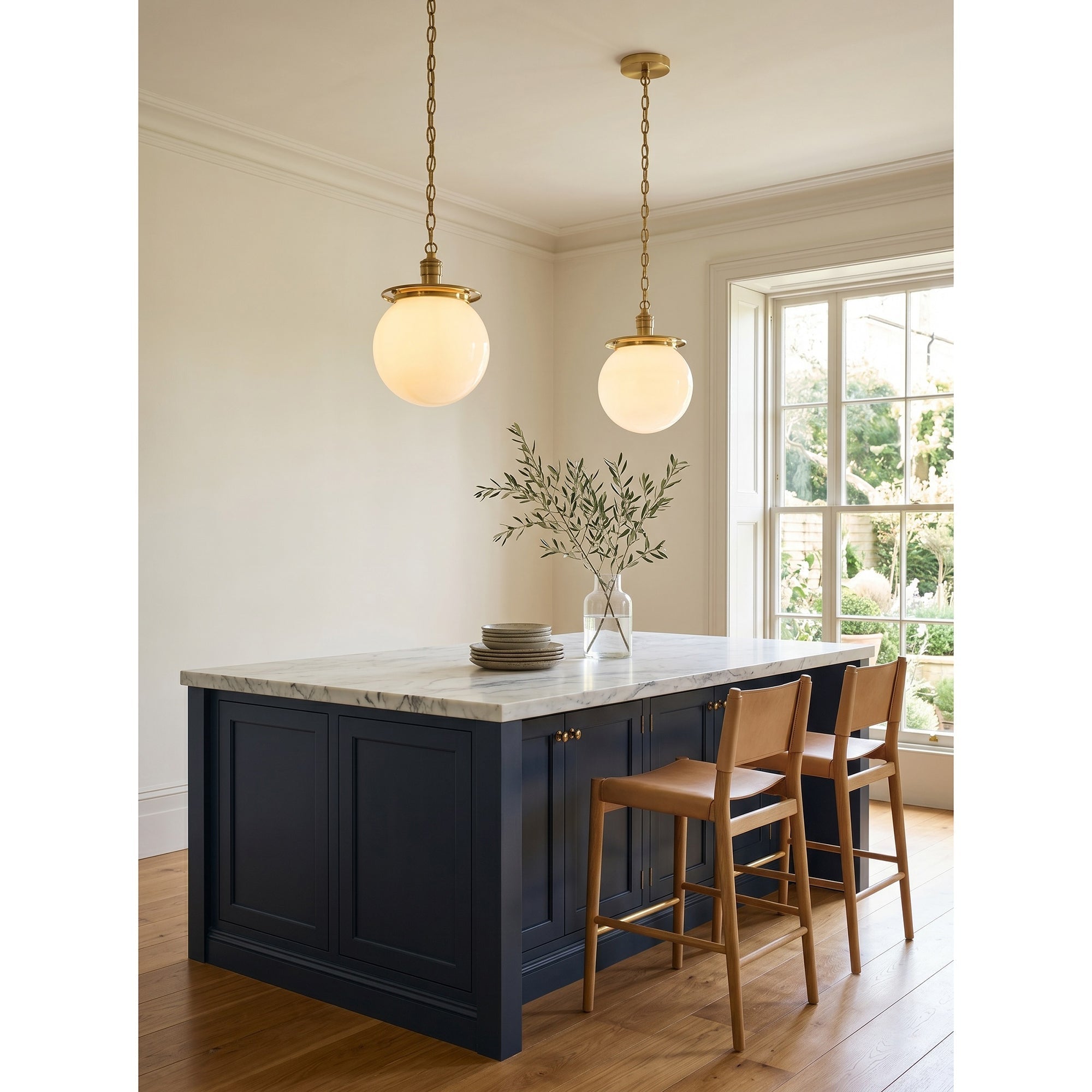 A pair of Nolan Globe Pendants hanging over a dining table.