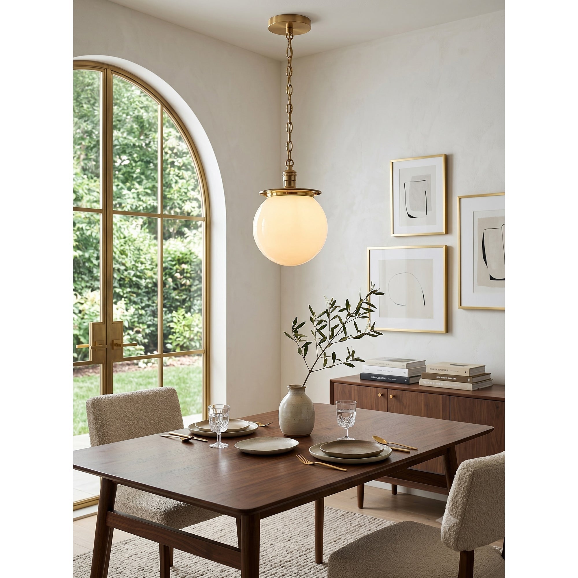 Angled view of the brass Nolan Globe Pendant Lamp.