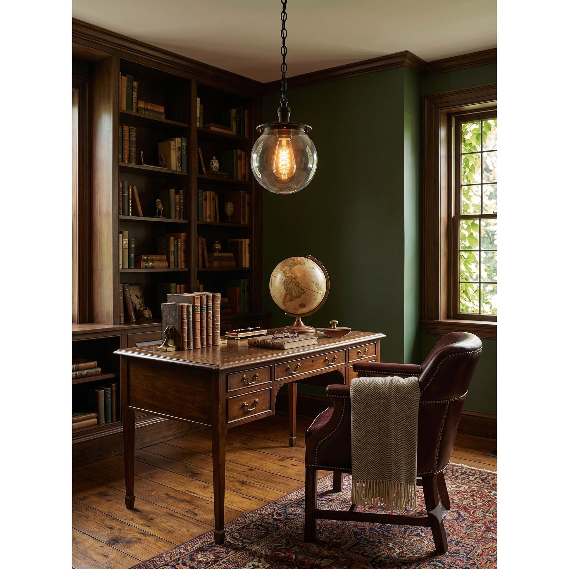Nolan Globe Pendant Lamp, brass finish with clear glass.