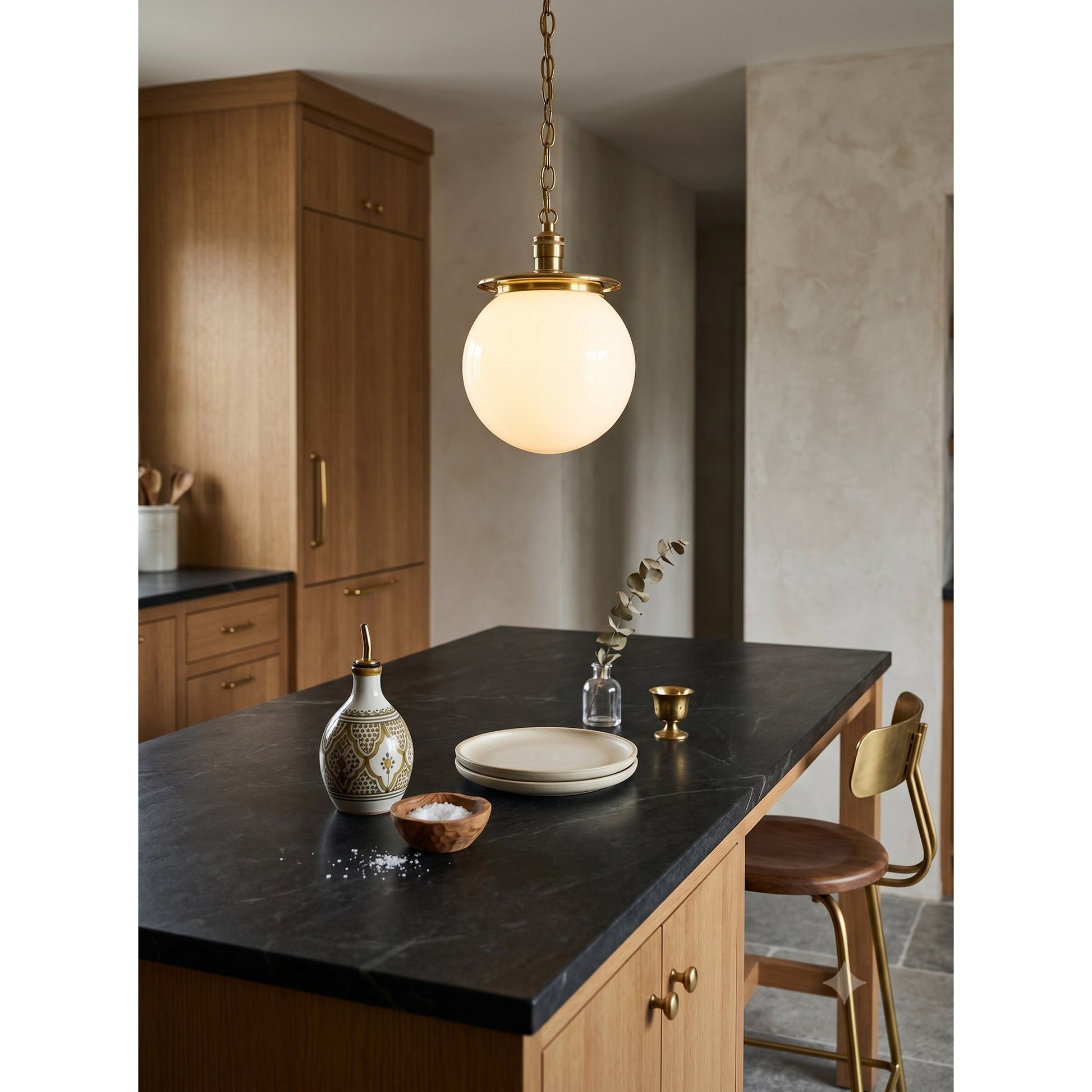 The Nolan Globe Pendant shown against a light wall.