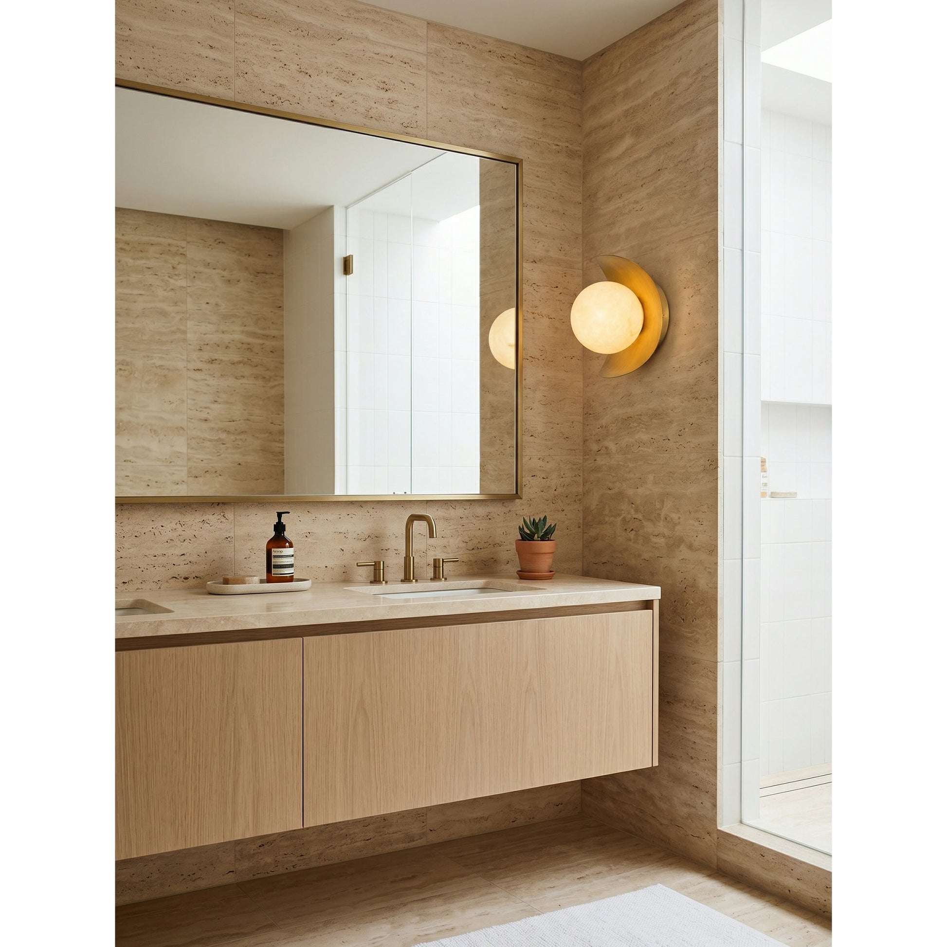The wall sconce installed in a bathroom setting next to a mirror.