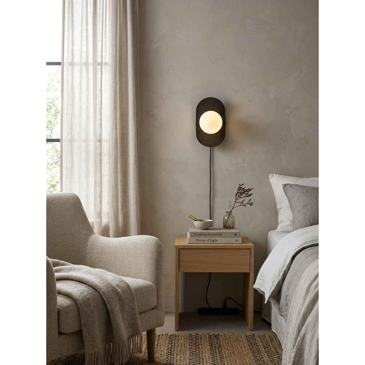 Nouvel Wall Sconce in rose gold finish.