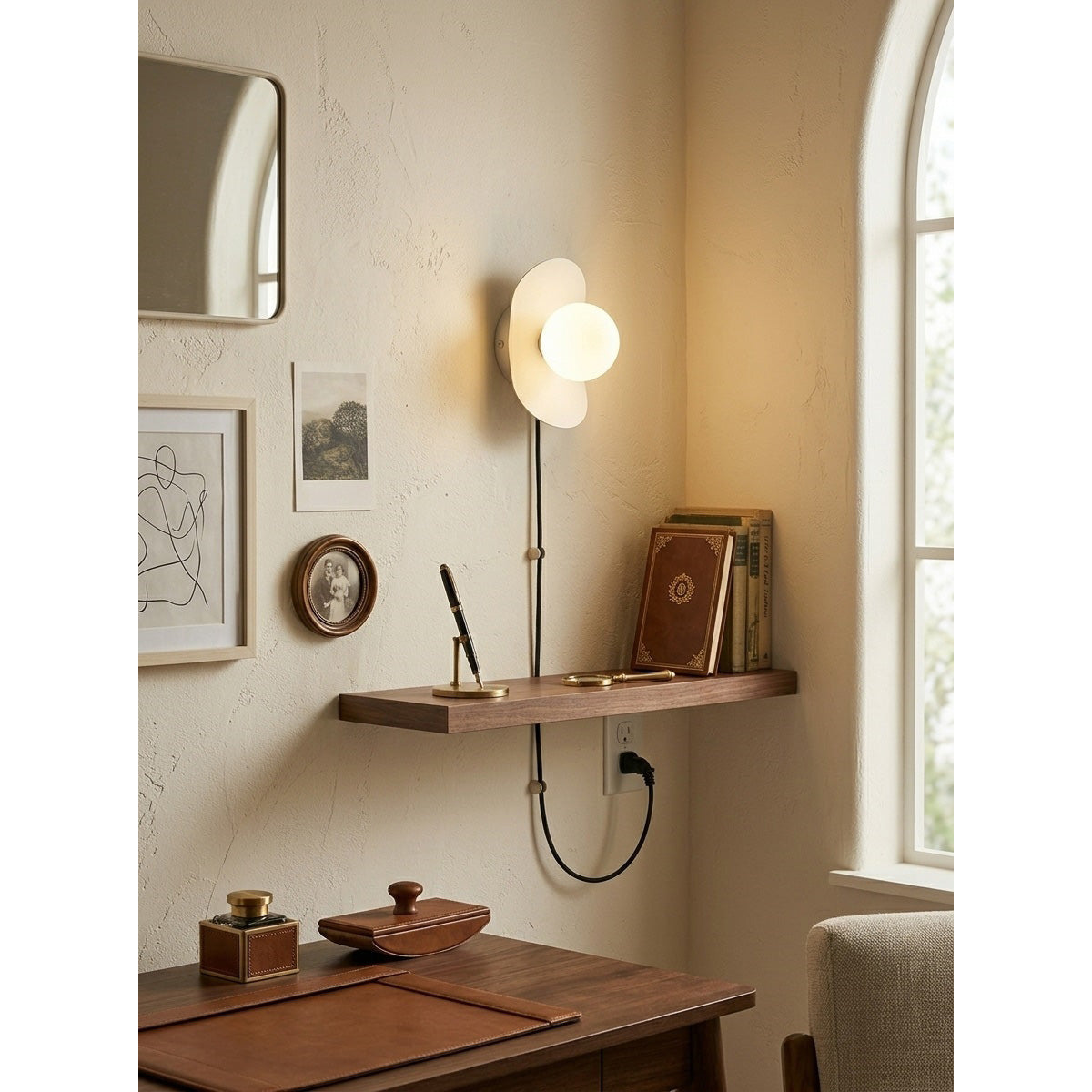 Lifestyle image of the Nouvel Wall Sconce used as a bedside reading light.