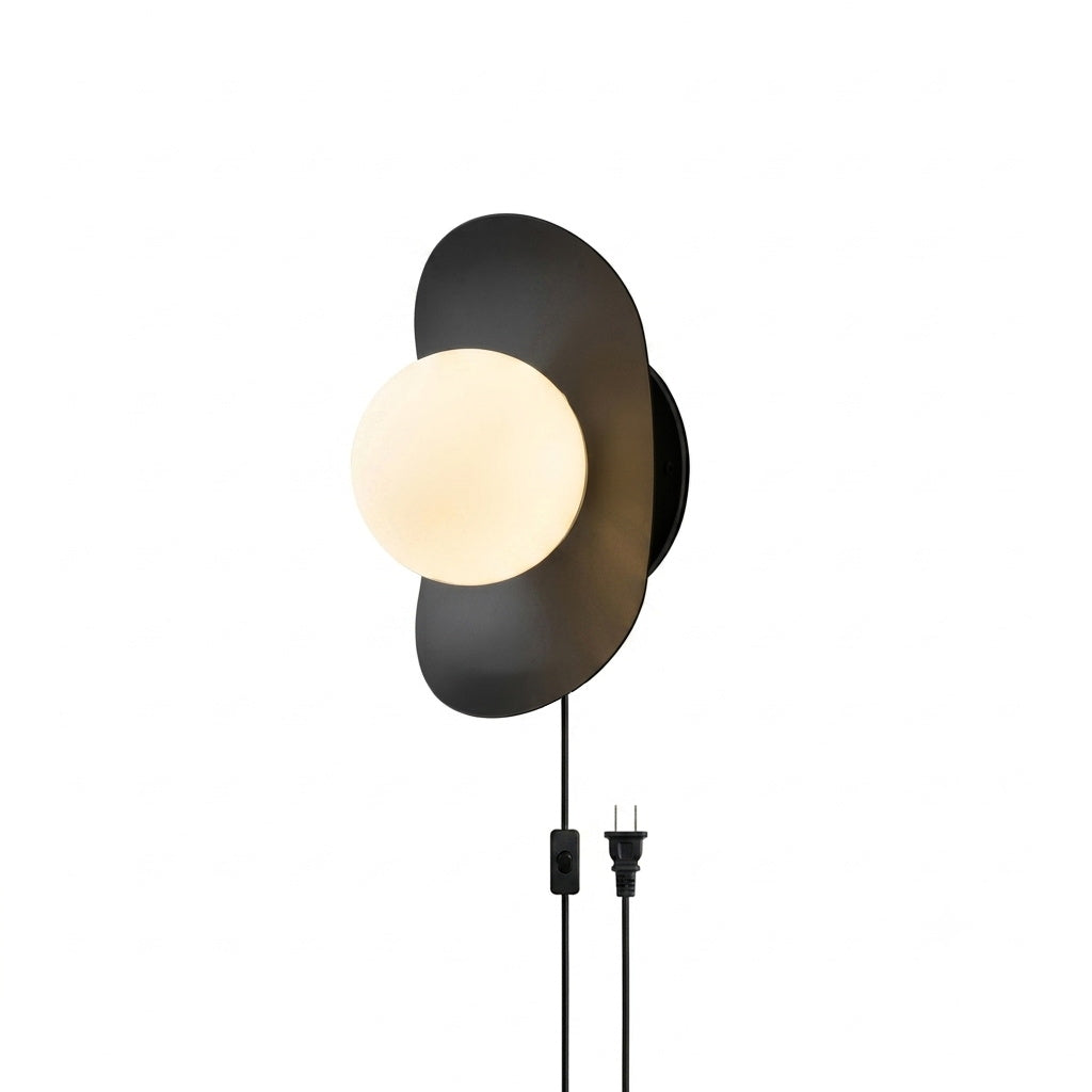 The frosted glass globe of the Nouvel Sconce, illuminated.