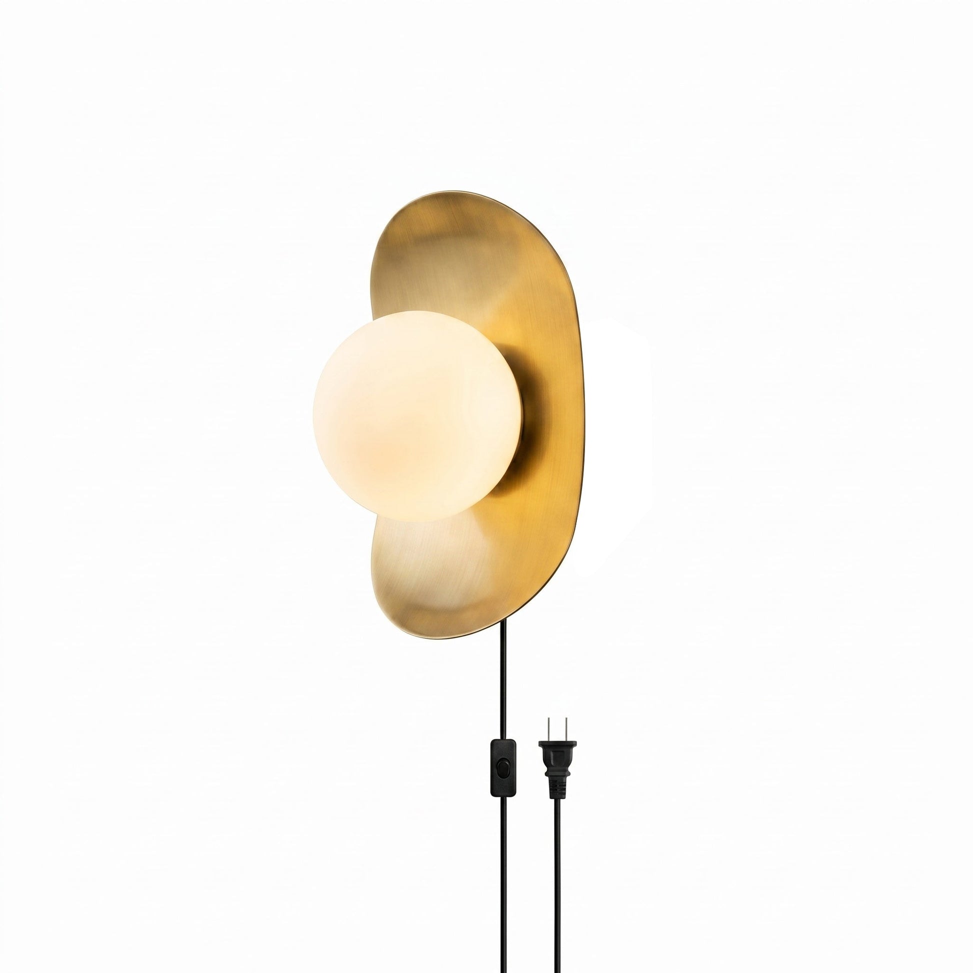 Nouvel Plug-in Wall Sconce in brass finish with frosted glass globe.