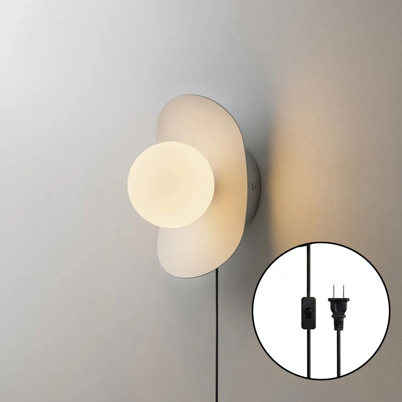 The frosted glass globe of the Nouvel Sconce, unlit.