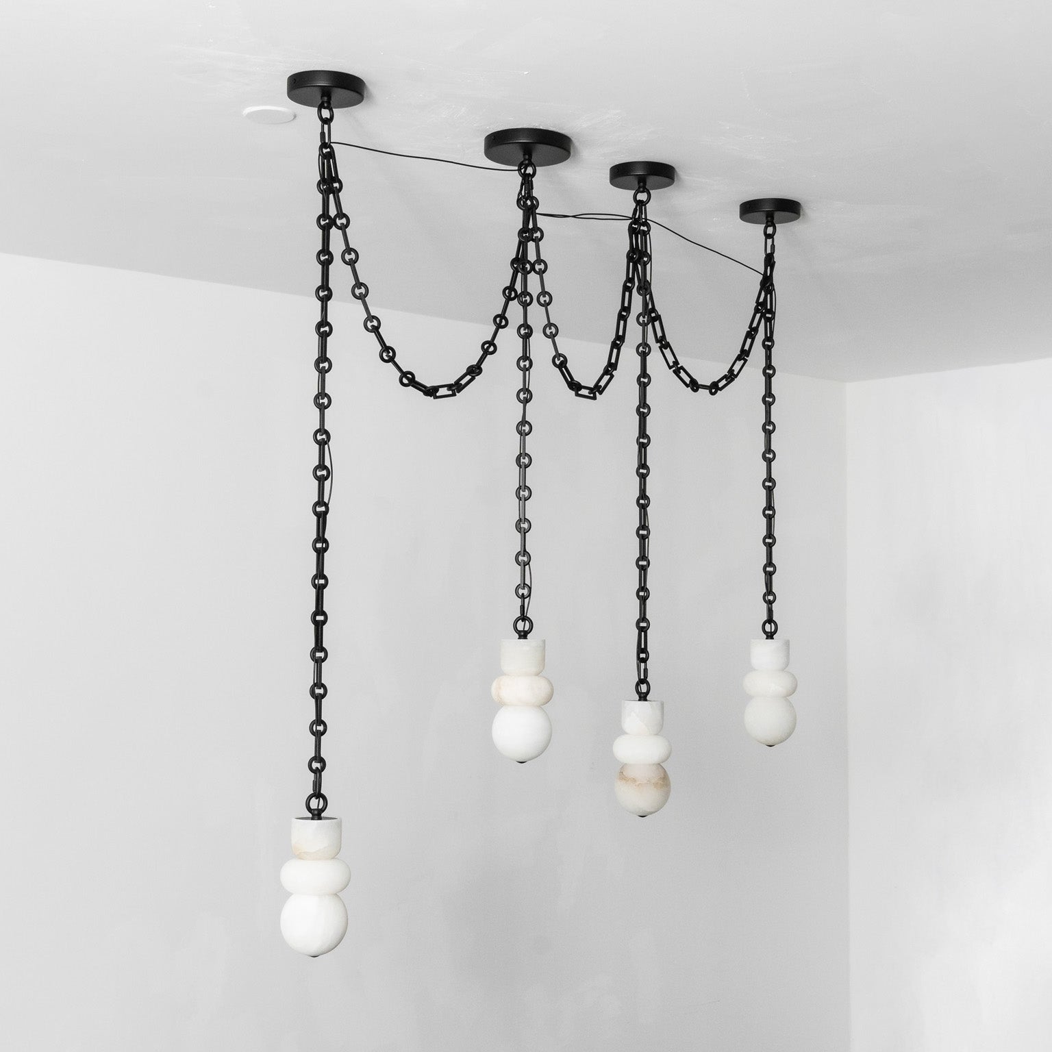 A nine-head configuration of the Orba Chain Alabaster Chandelier.