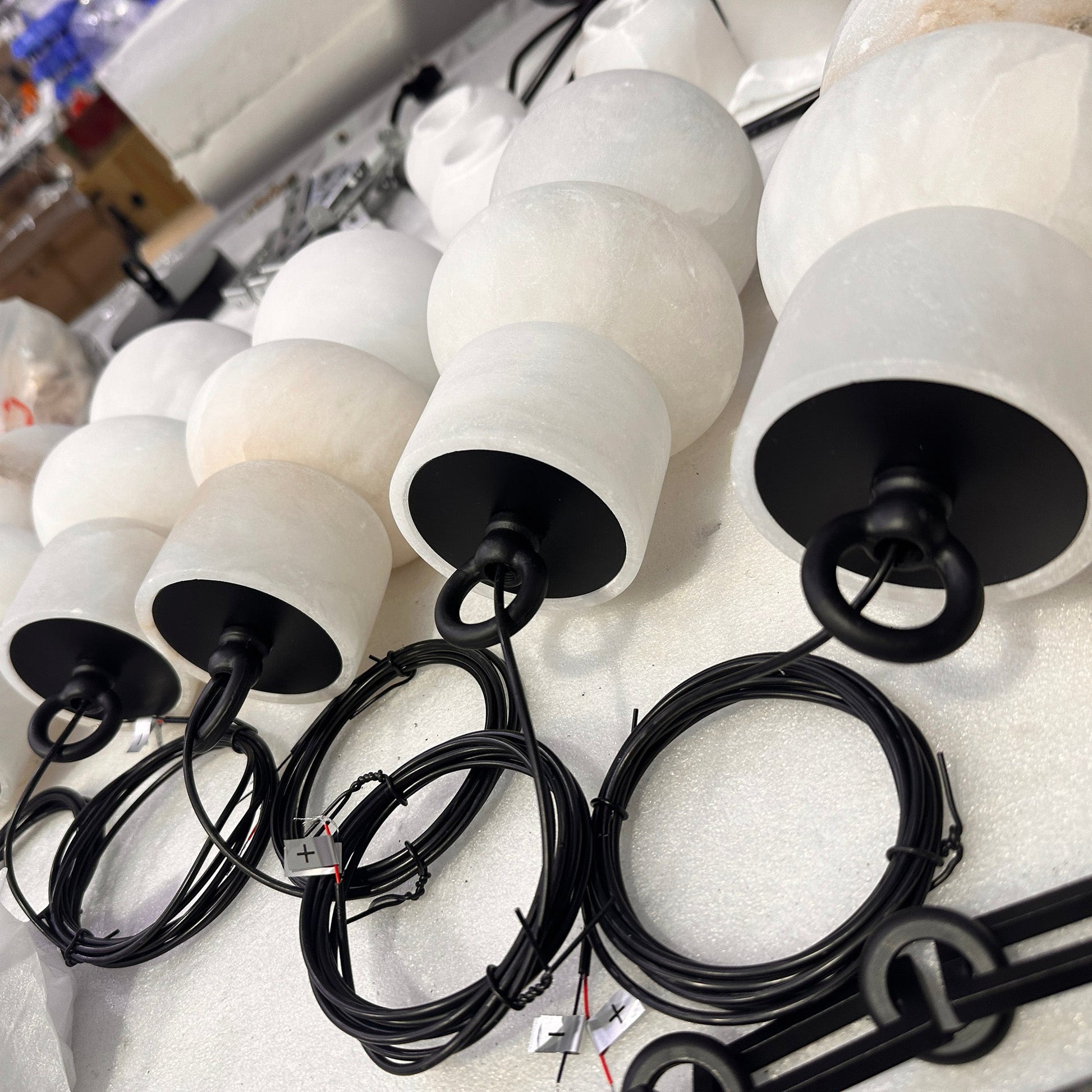 Detailed view of the suspension point for the Orba chandelier's chains.