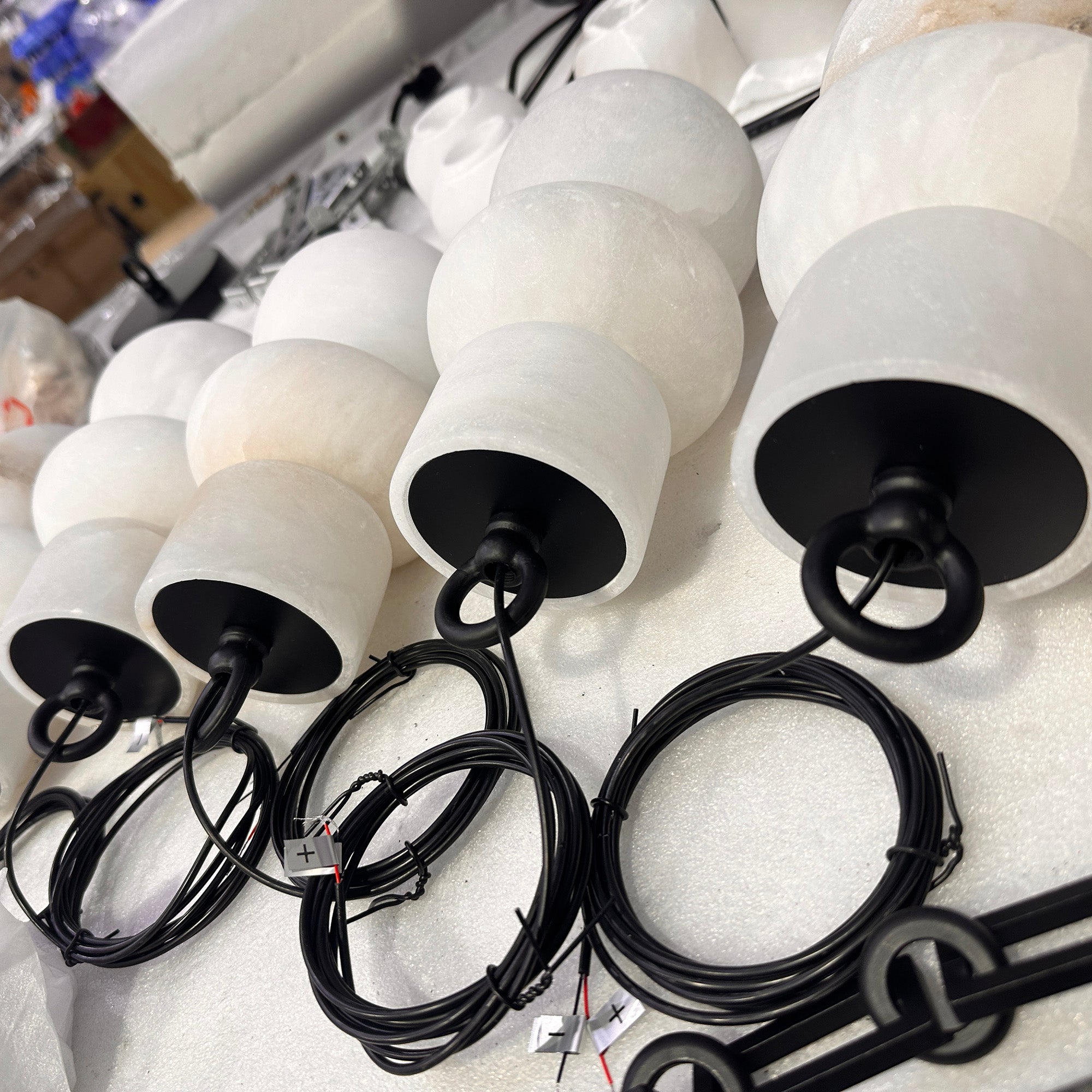 Detailed view of the suspension point for the Orba chandelier's chains.