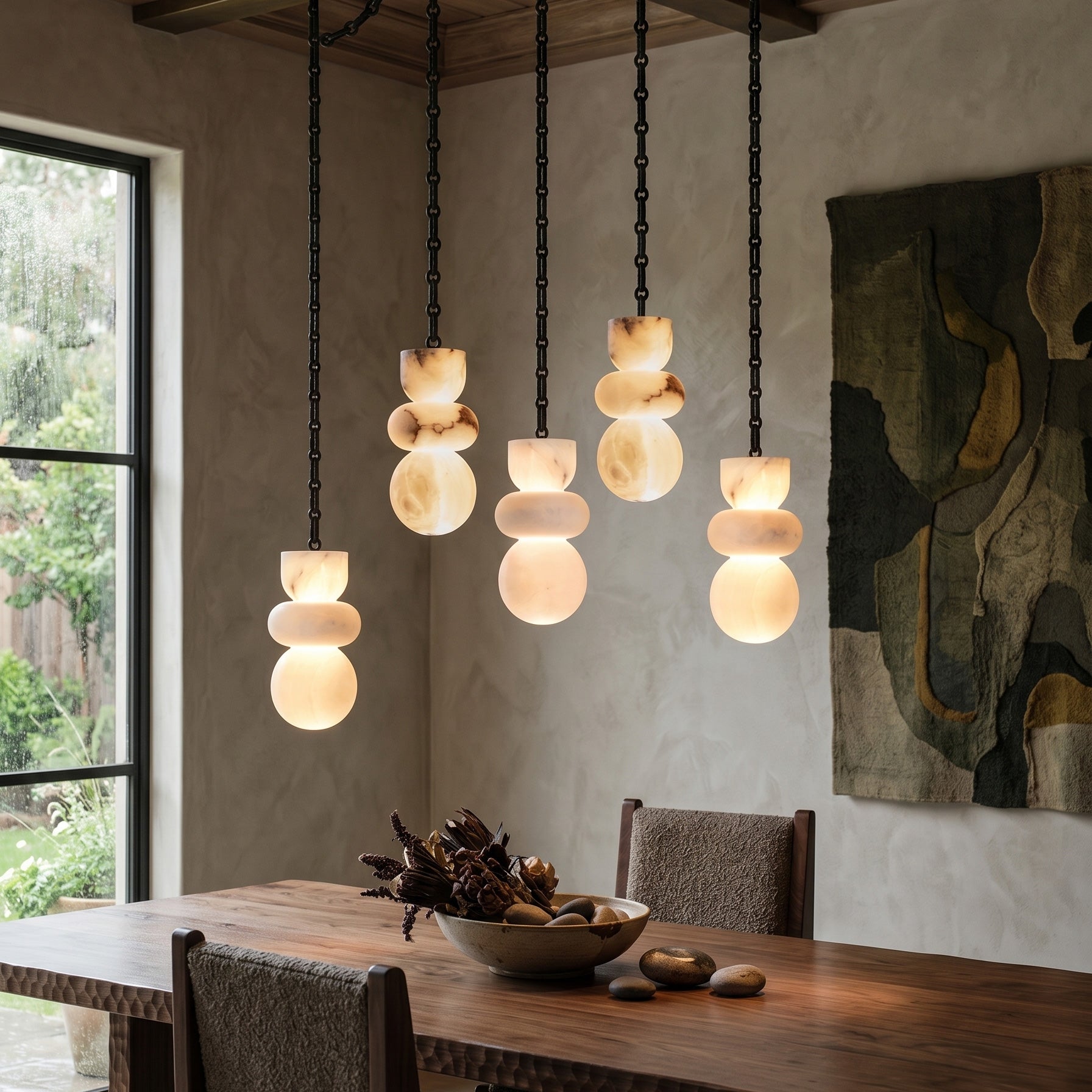 Orba Chain Alabaster Chandelier against a dark, textured wall.