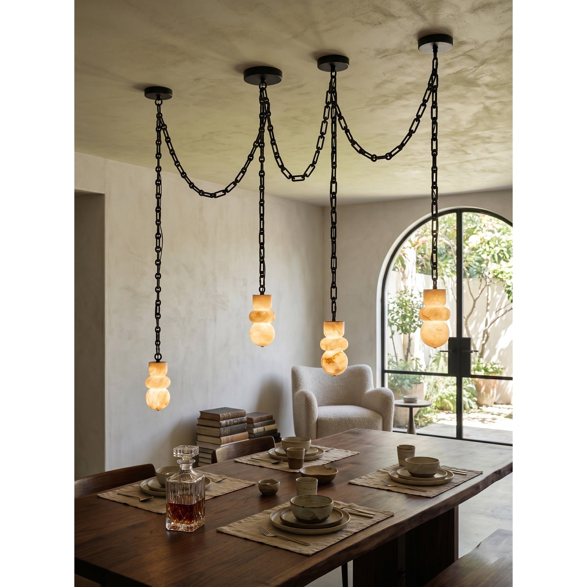 The Orba chandelier with lights off, showing the alabaster's natural texture.