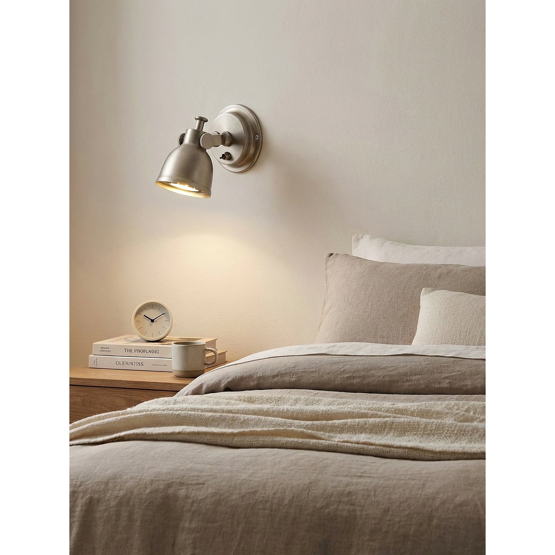 The Orwell Wall Sconce's adjustable head tilted downwards for direct light.