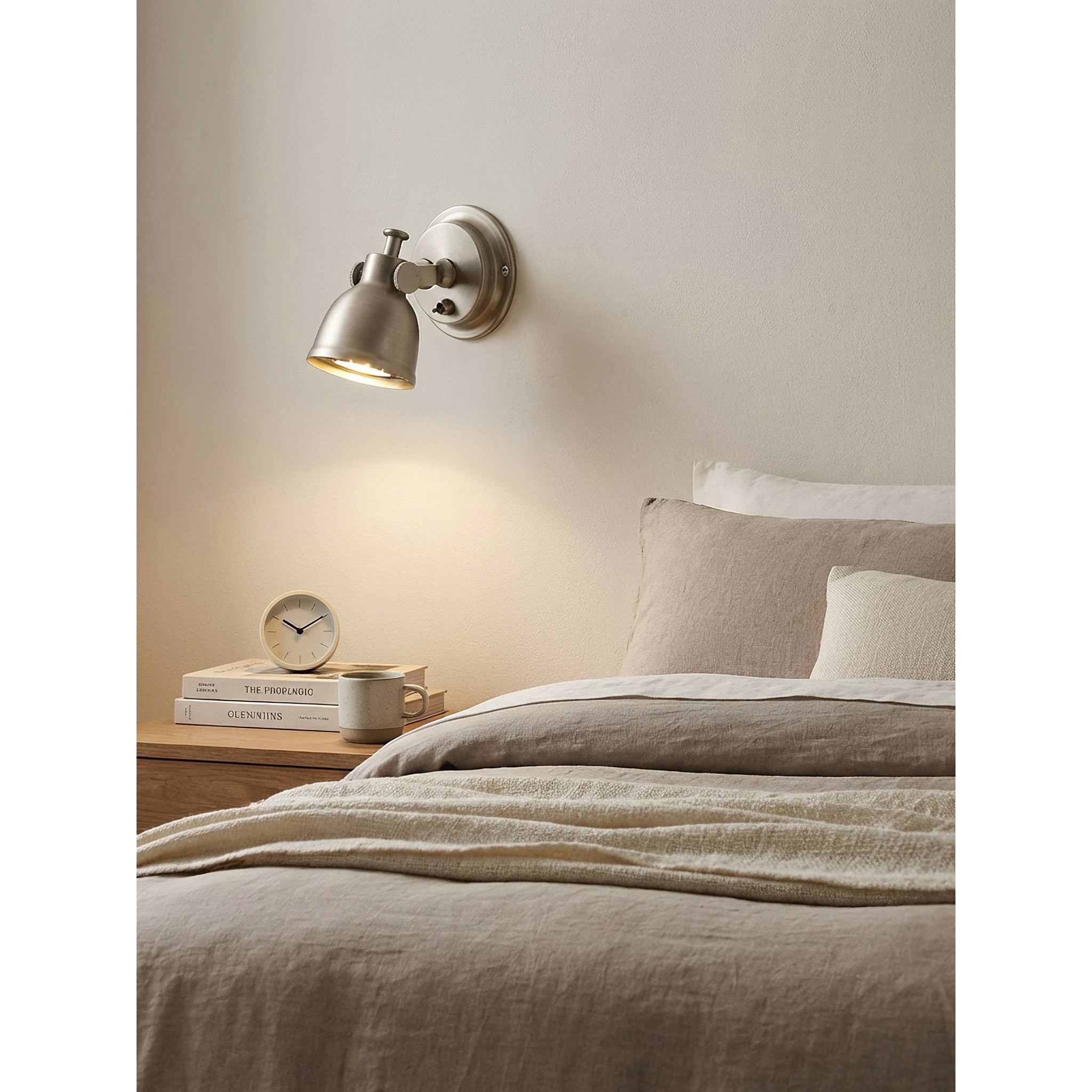 The Orwell Wall Sconce's adjustable head tilted downwards for direct light.
