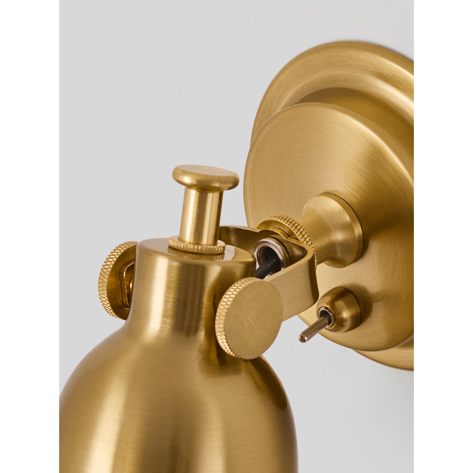 Close-up of the toggle switch on the copper finish sconce.