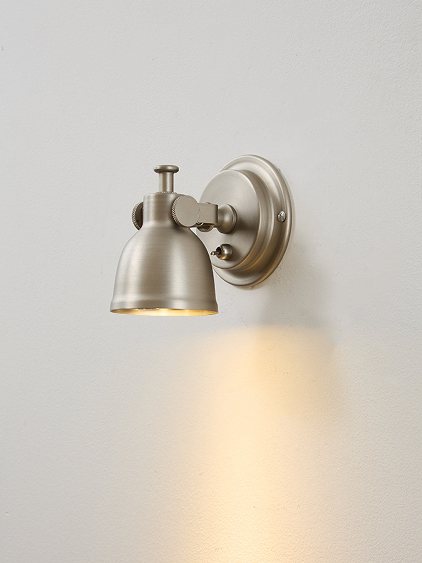 Orwell Wall Sconce mounted on a dark, moody wall for a dramatic effect.