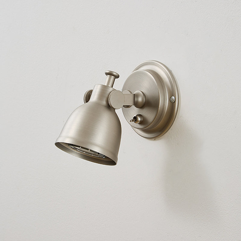 Orwell Wall Sconce casting a warm, ambient glow in a dimly lit room.