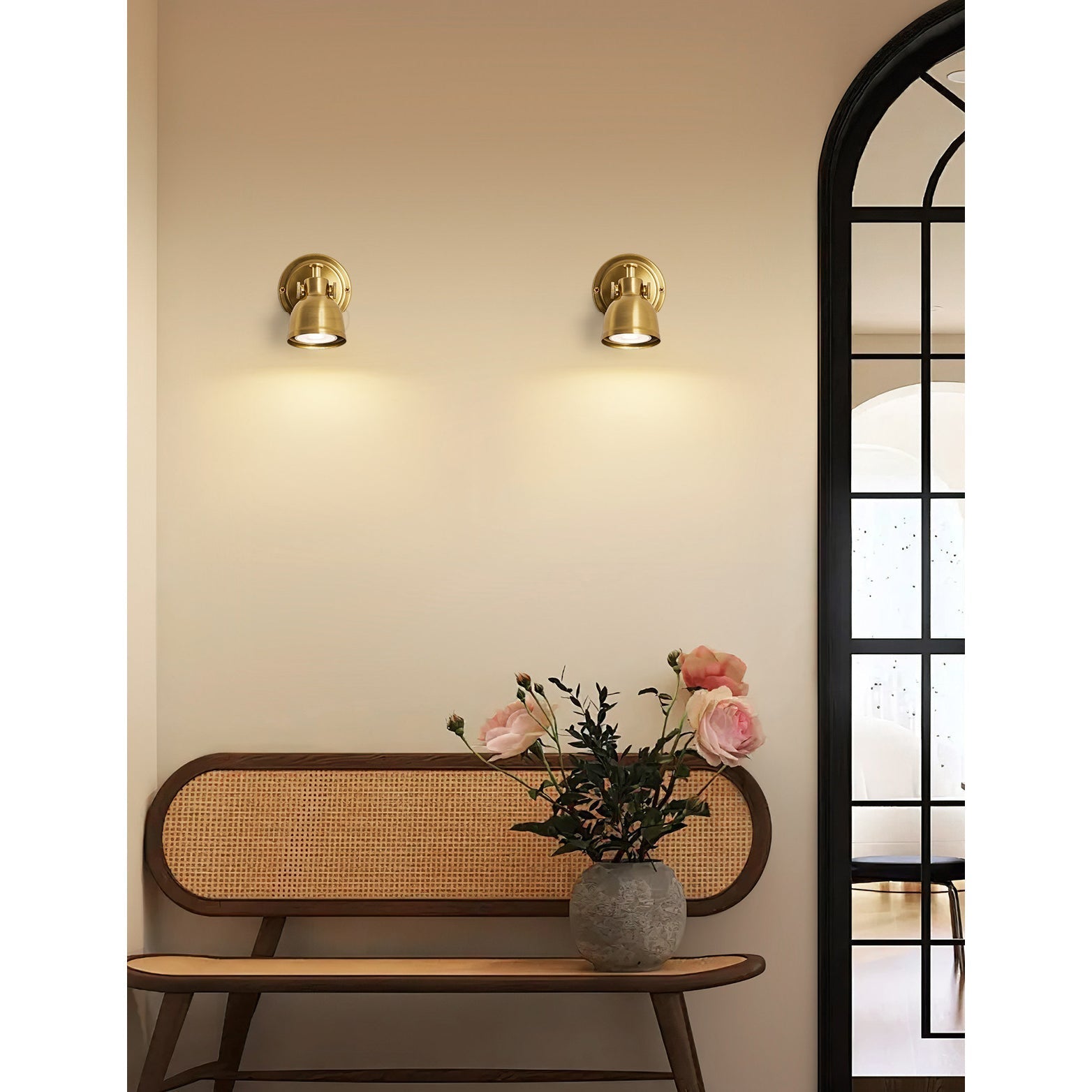 The rich copper finish of the Orwell Wall Sconce glowing in warm light.