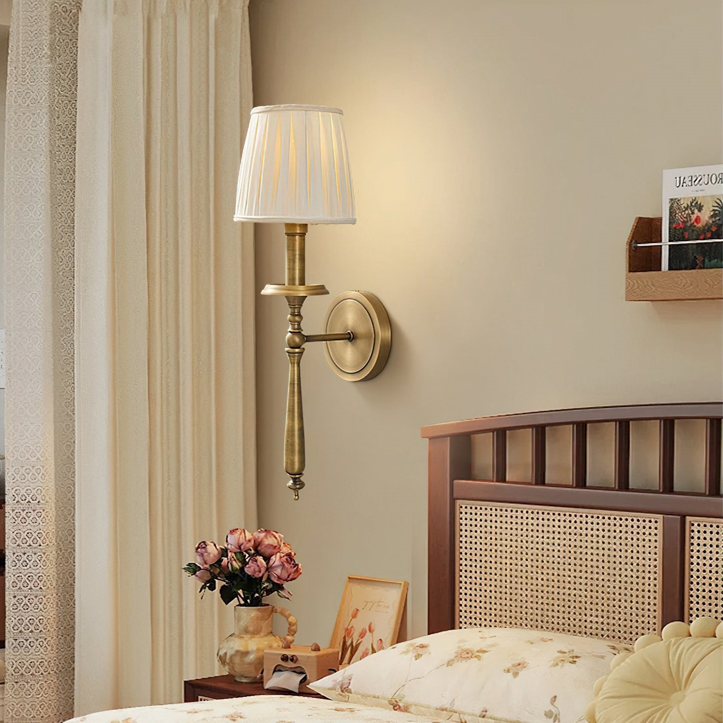 Detailed view of the antique brass arm and wall plate.