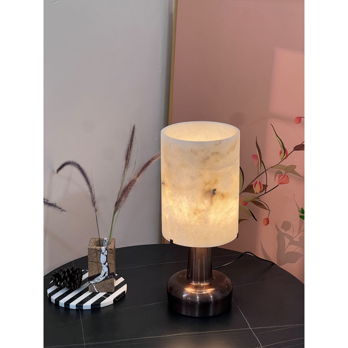 The pear-shaped lamp from a low angle, emphasizing its sculptural base.