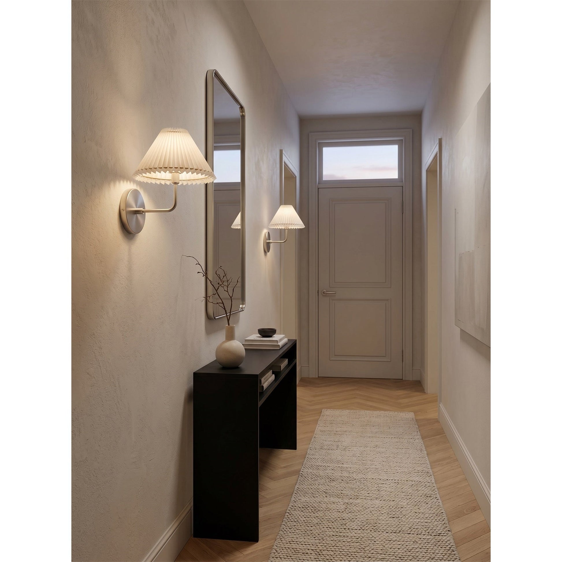 Pearson Wall Sconce in brass finish against a dark, moody wall.