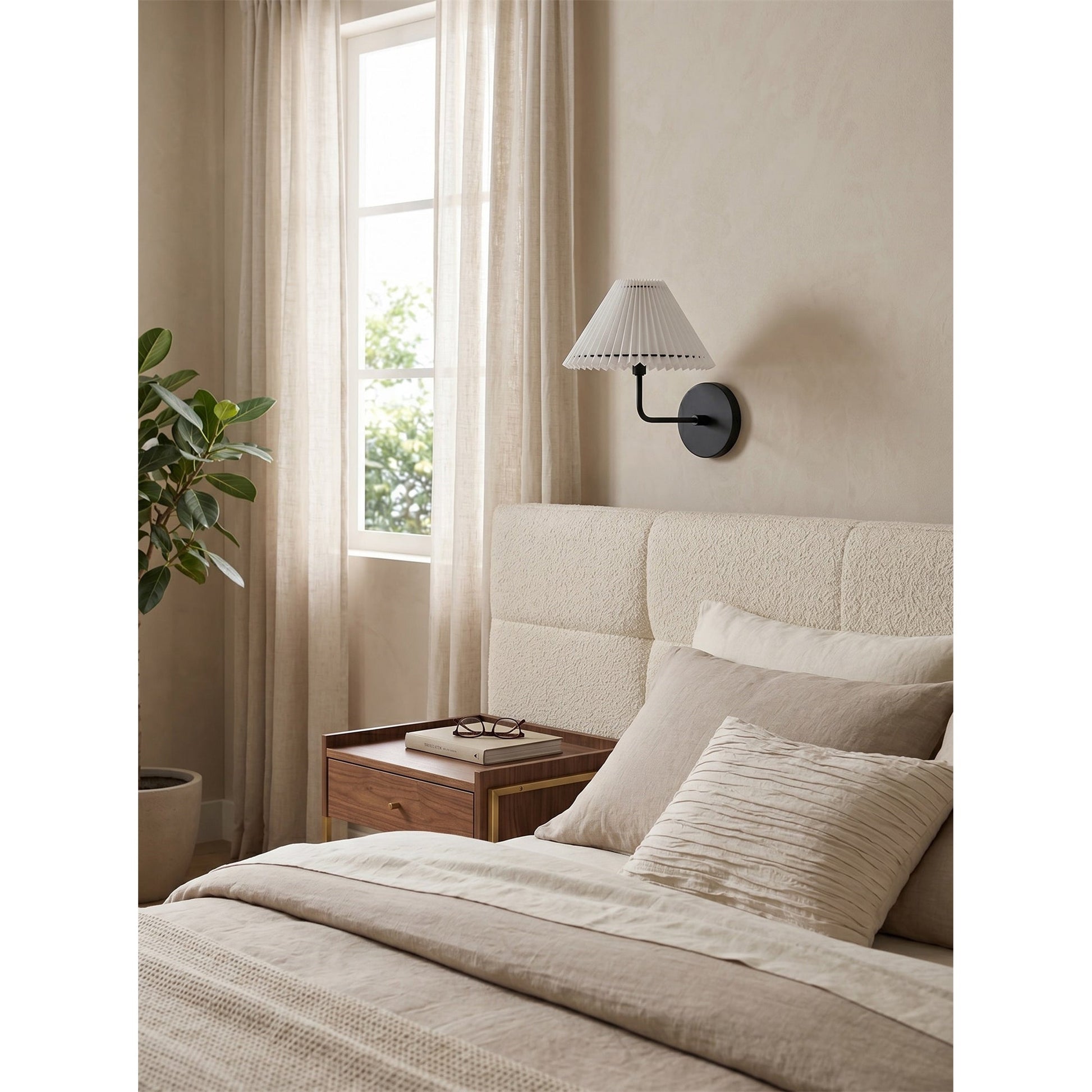 Pearson Wall Sconce shown in a chic bedroom setting beside a bed.