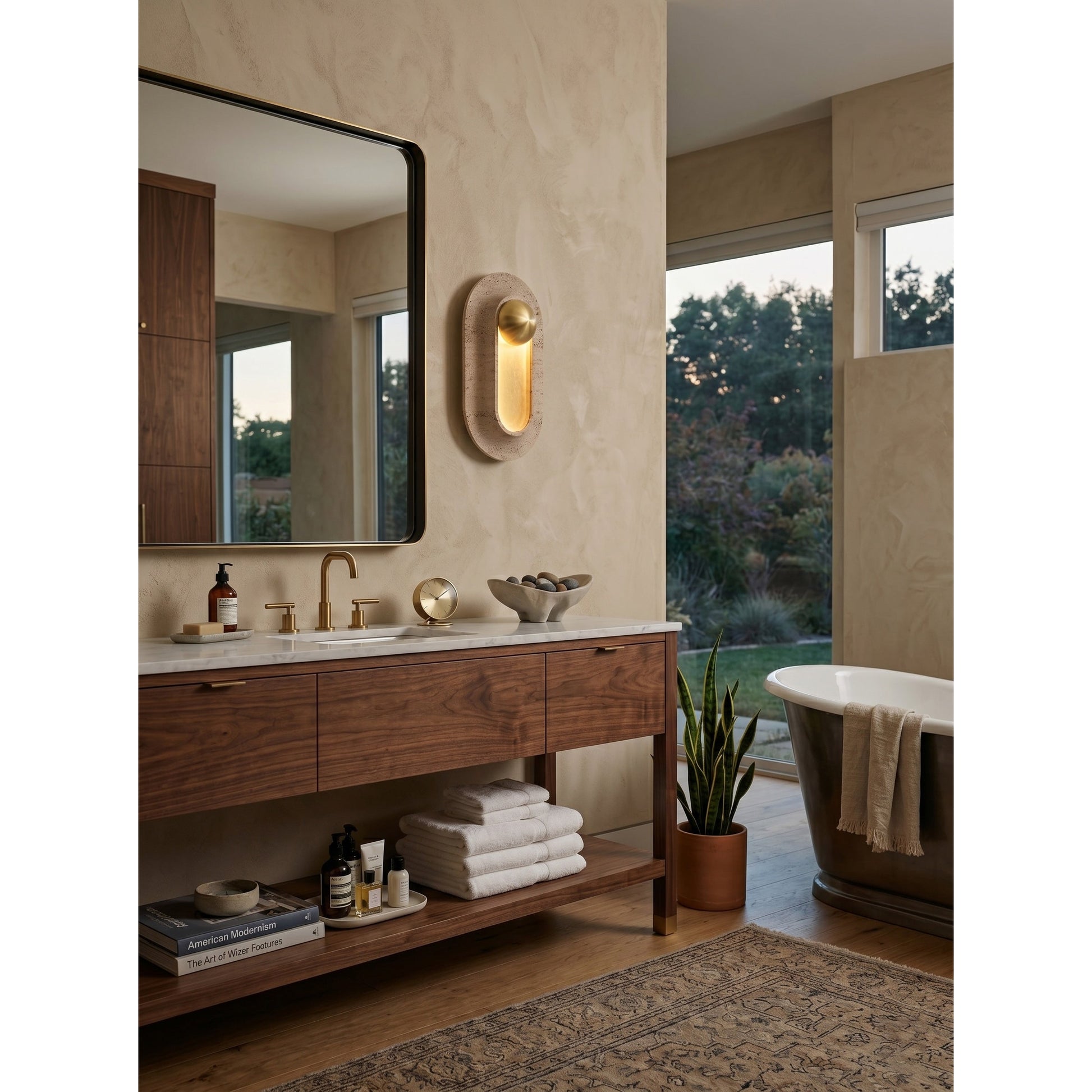 The wall sconce shown against a dark wall to emphasize its form and light.