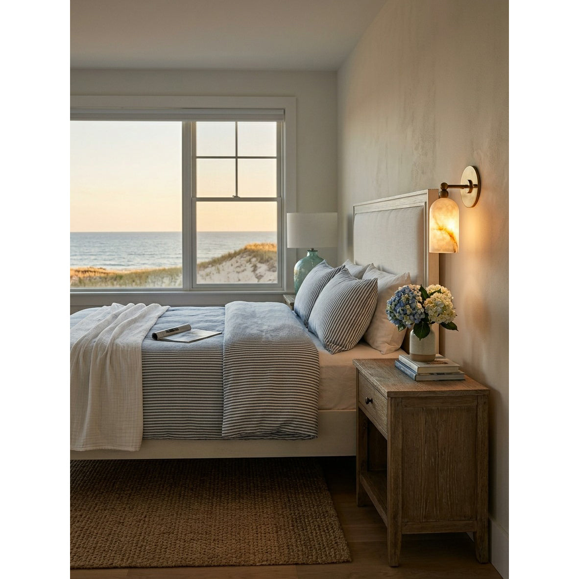 The wall sconce used as a bedside light in a cozy bedroom.